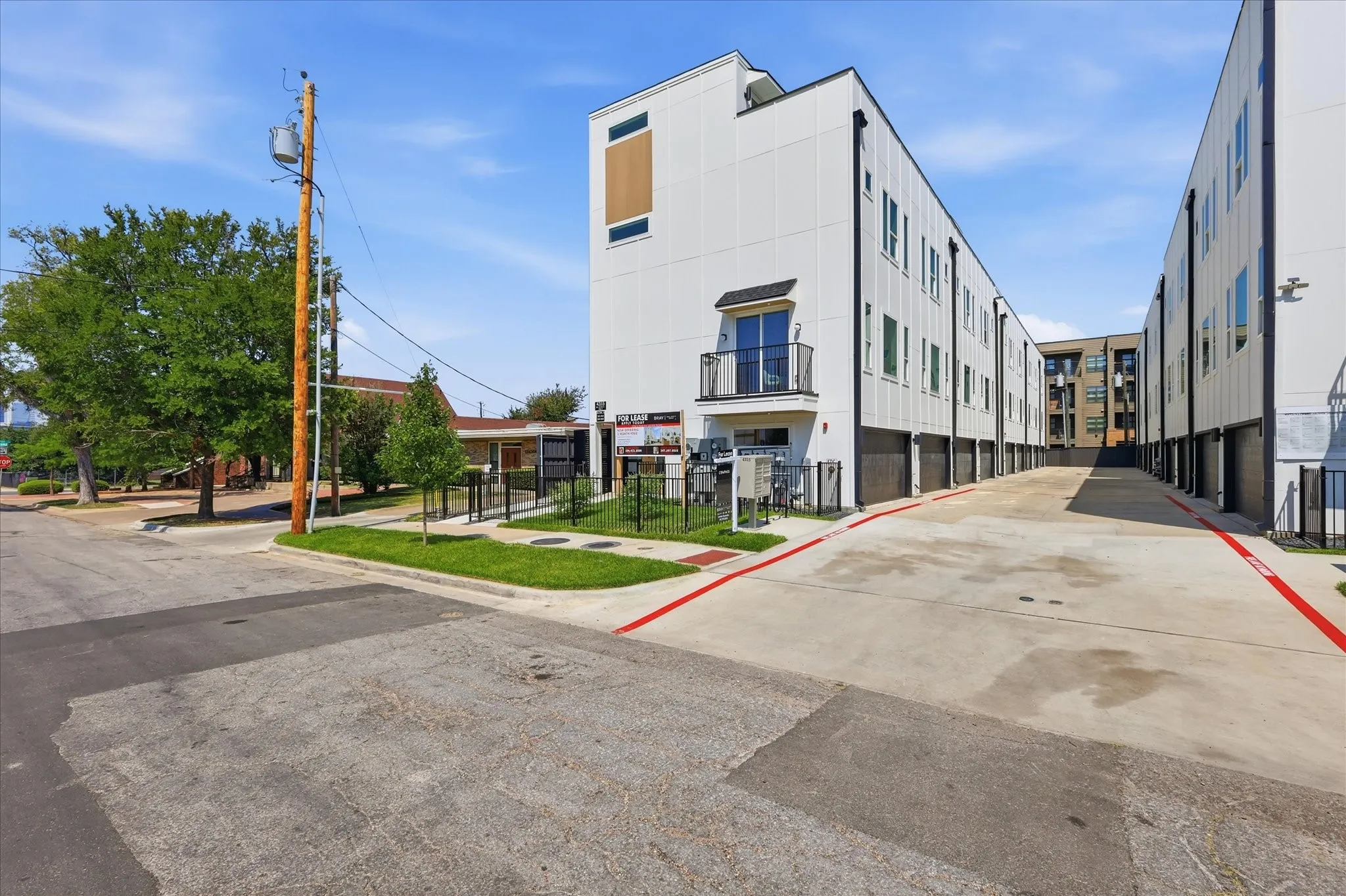 Modern multi-story facade featuring white paneling and dark accents