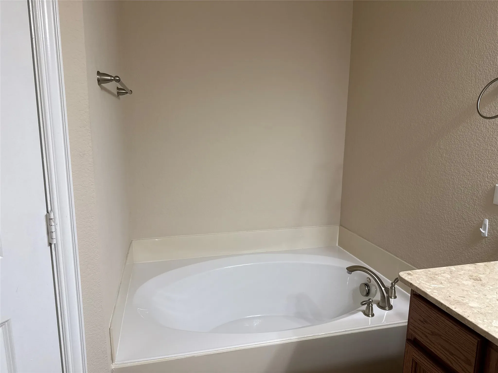 Built-in soaking tub with brushed nickel fixtures