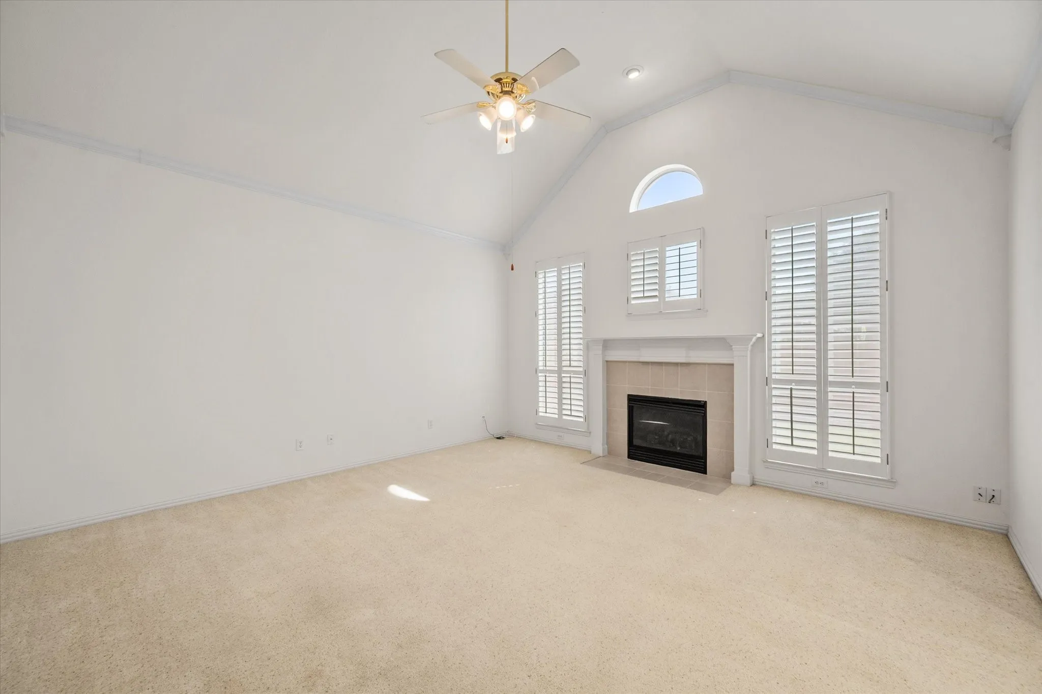 Living room opens to breakfast area and has fireplace and plantation shutters