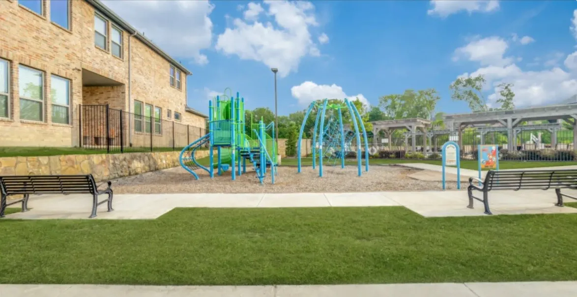 Community Outdoor recreation area featuring a playground with slides and climbing structures, along with a separate climbing net