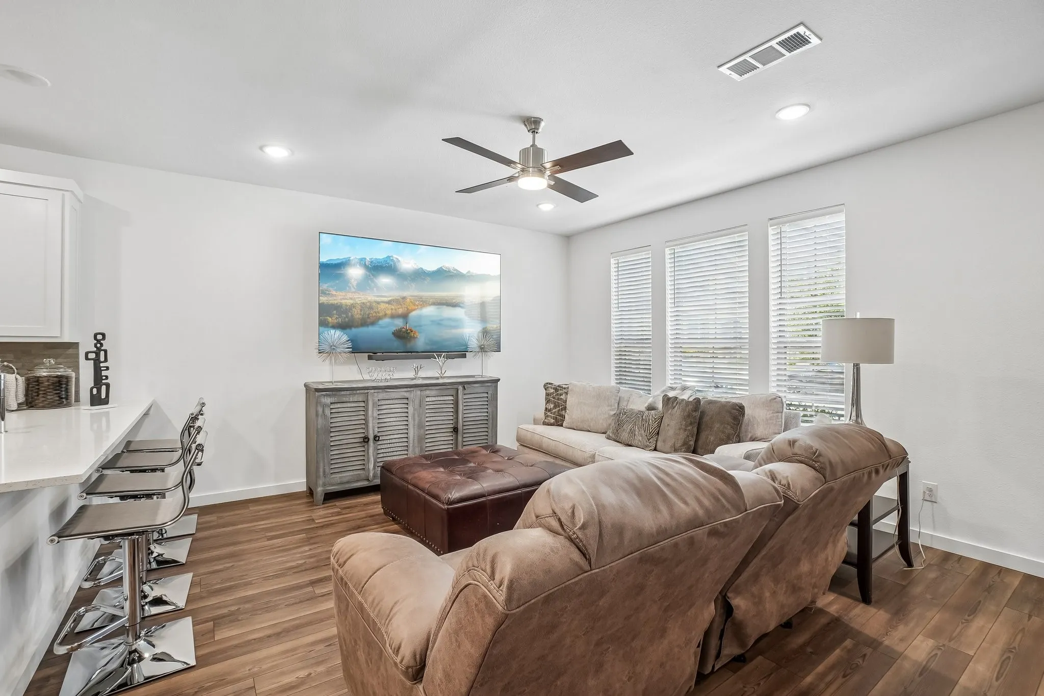 Open-concept living area featuring wood-finish flooring, recessed lighting, and a ceiling fan