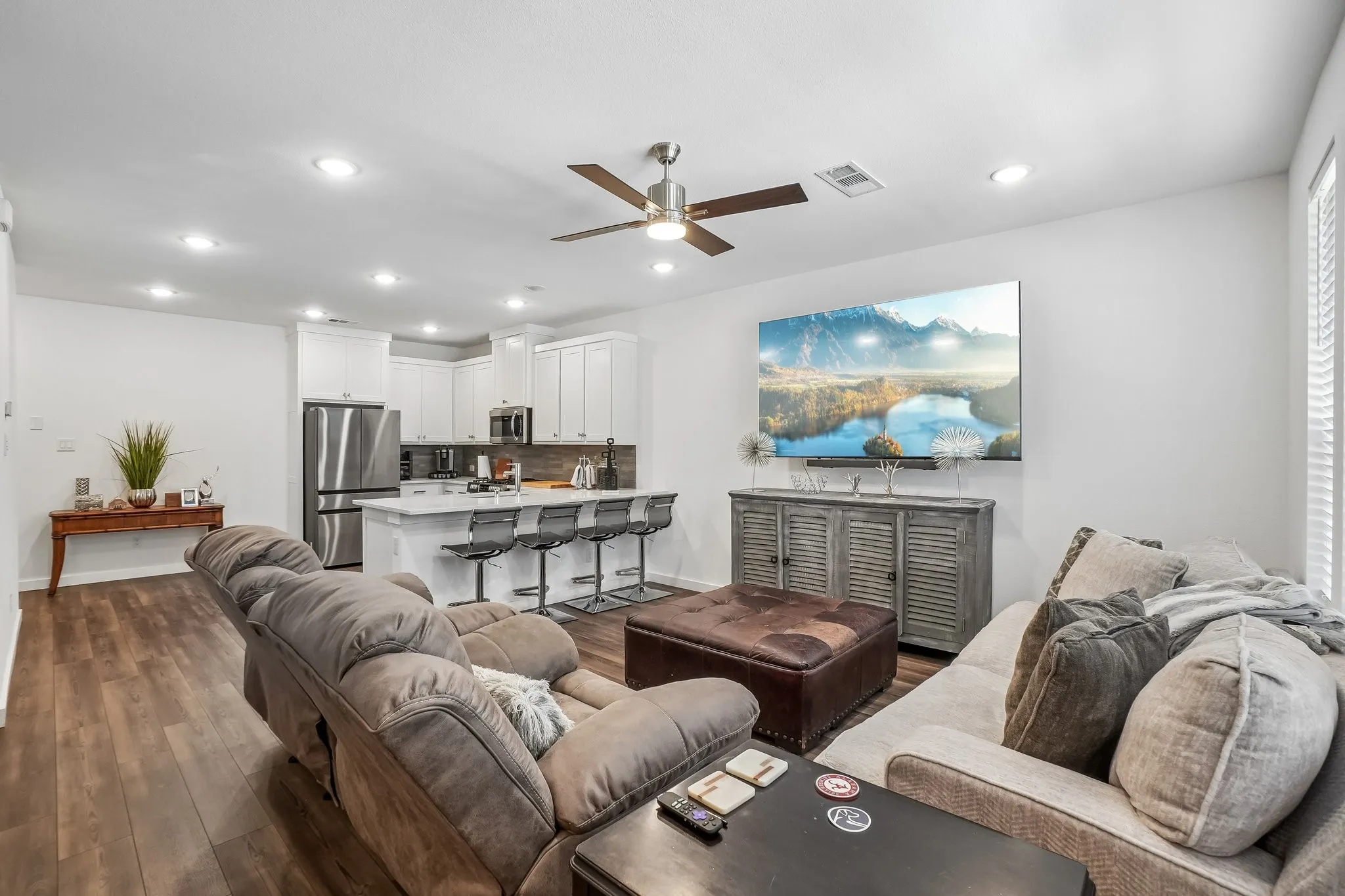 Open-concept living area featuring wood-finish flooring, recessed lighting, and a ceiling fan