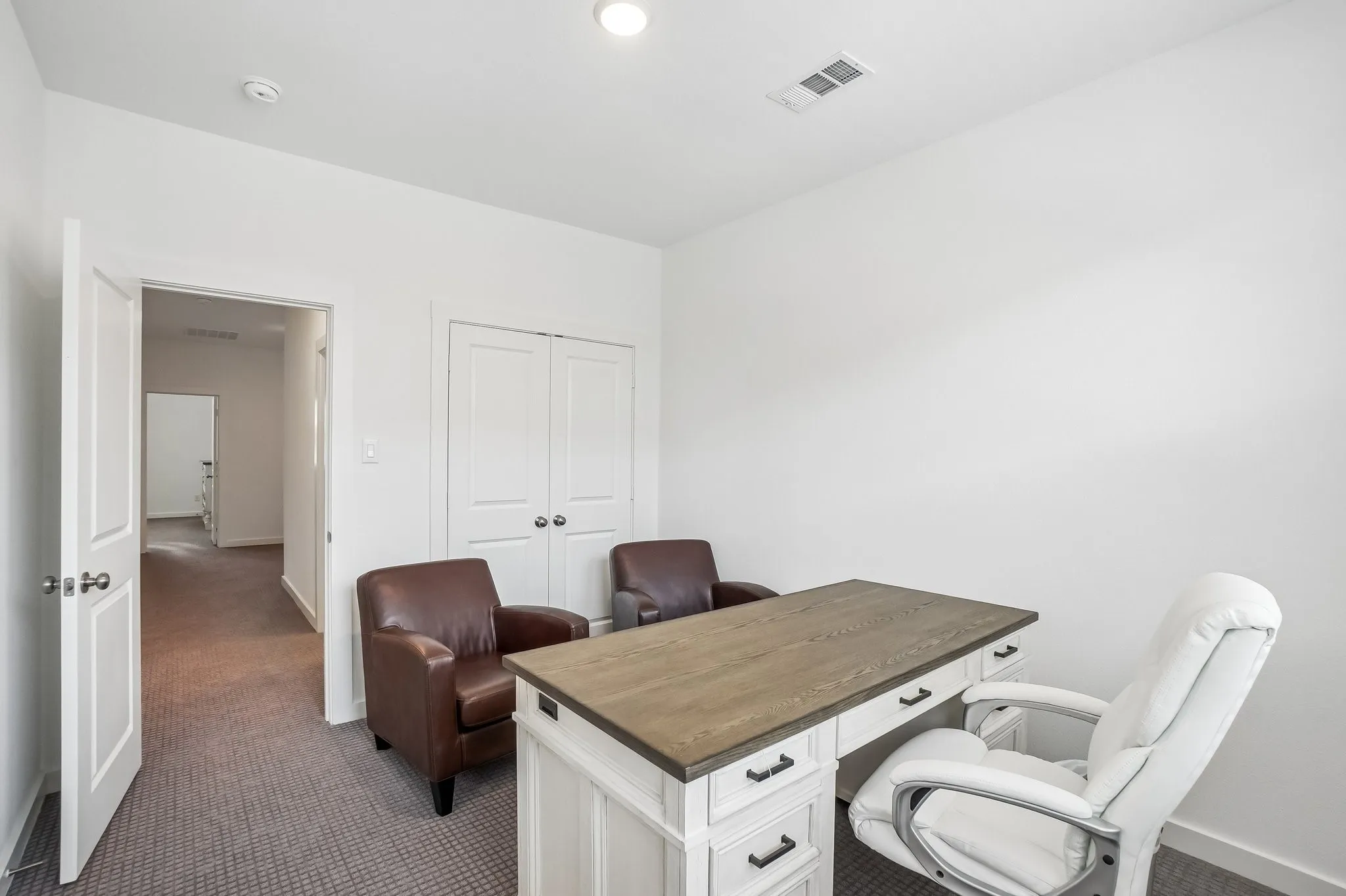 Room with light gray carpet flooring and white walls