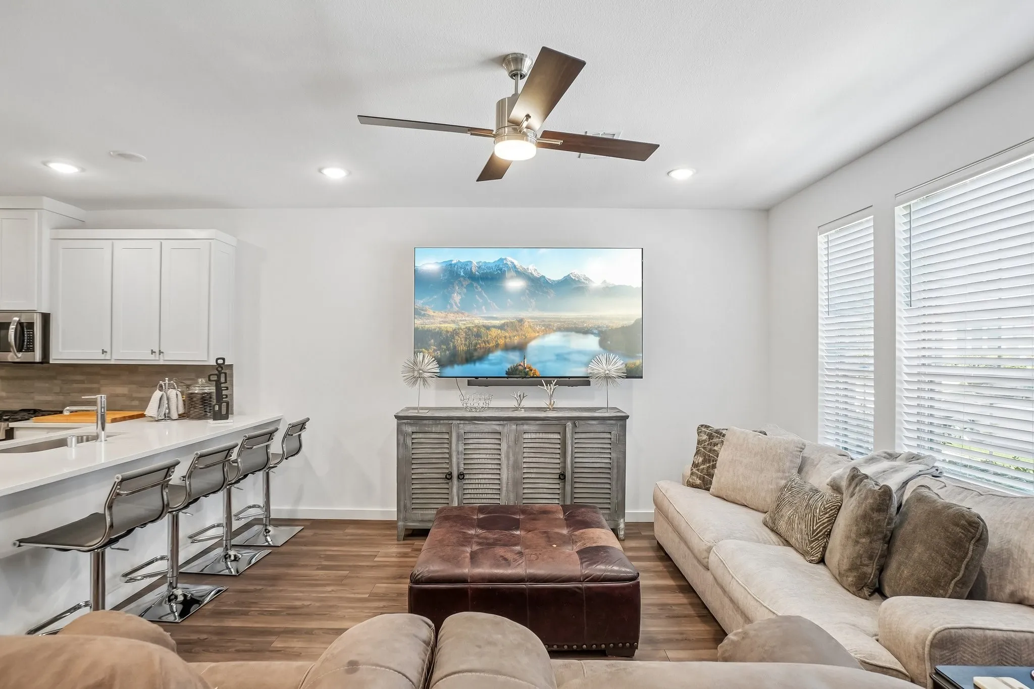 Open-concept living space featuring wood-finish flooring, recessed lighting, and a ceiling fan