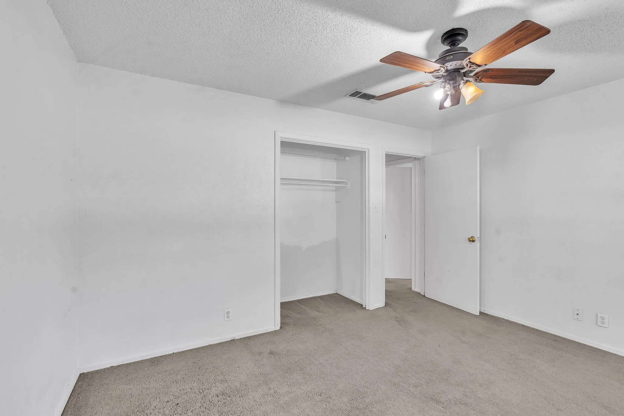 Neutral-toned carpet flooring and white painted walls