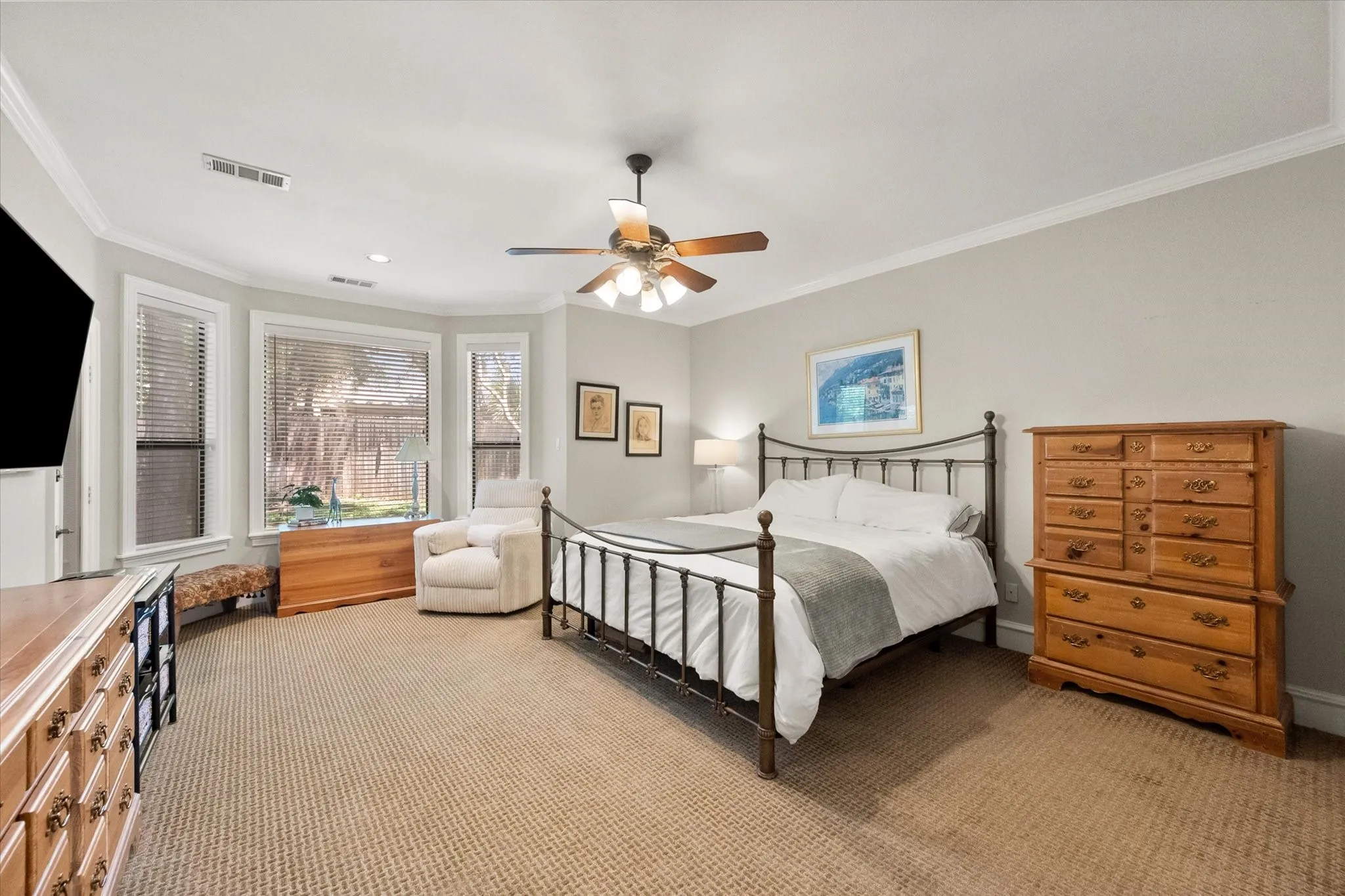 The primary bedroom is large and has a nice sized sitting area overlooking the backyard