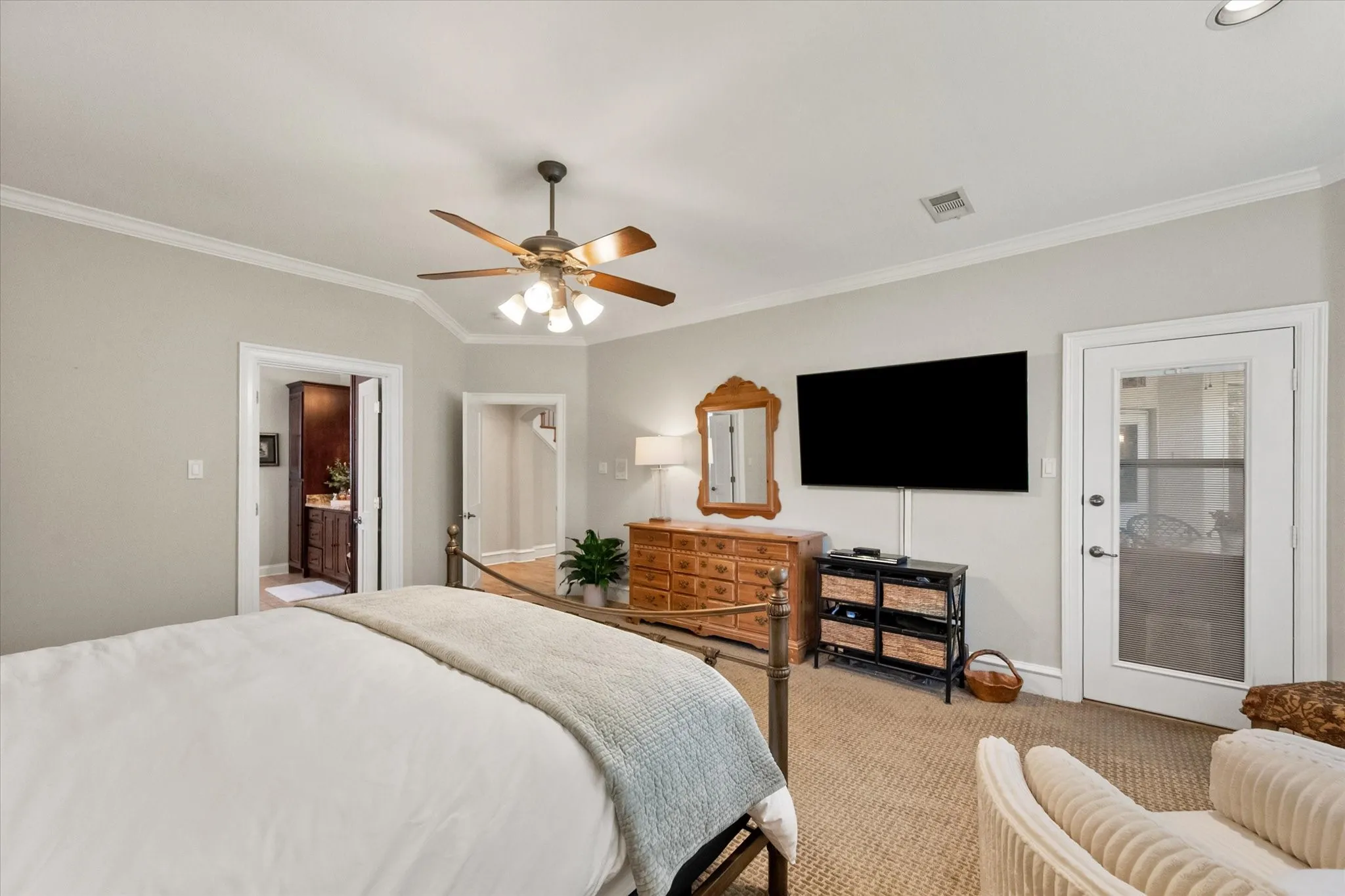 The large primary bedroom has a door to access the patio and backyard