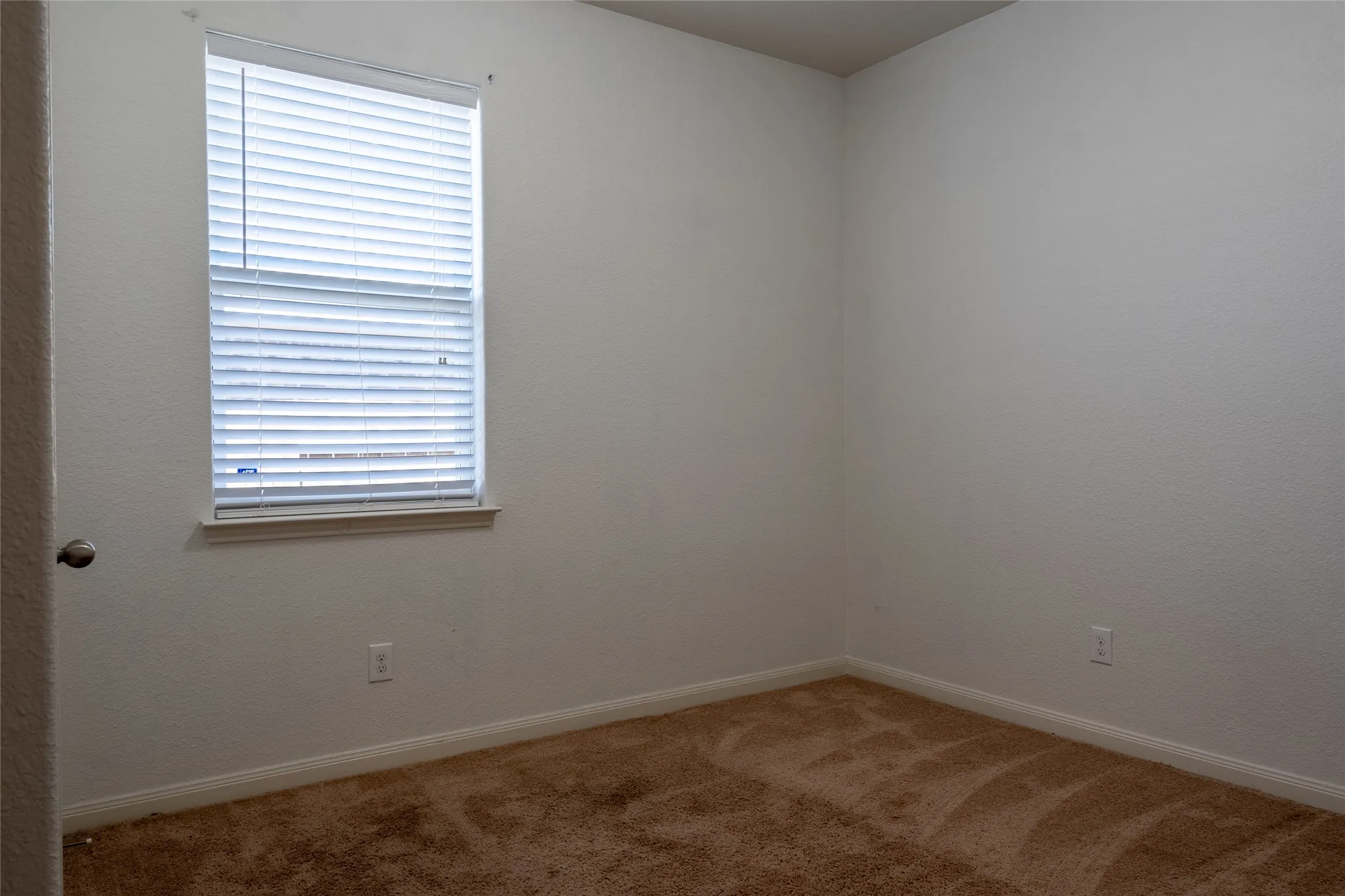 Empty room with plenty of natural light and carpet flooring
