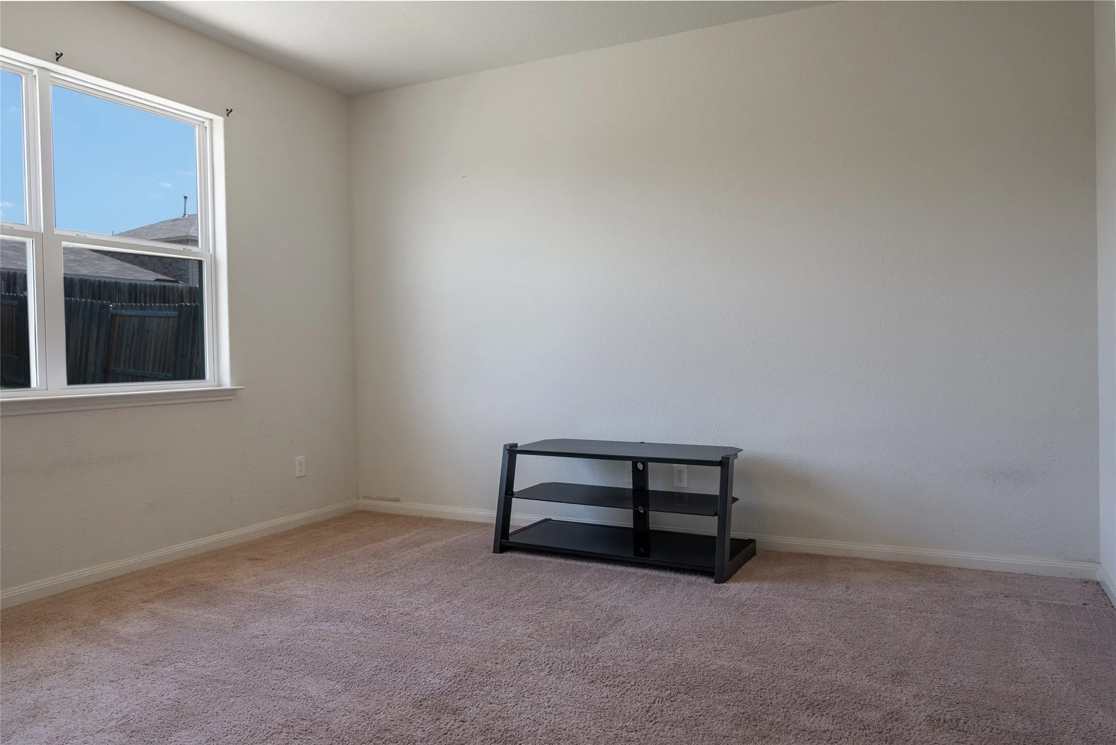 Spare room featuring carpet flooring