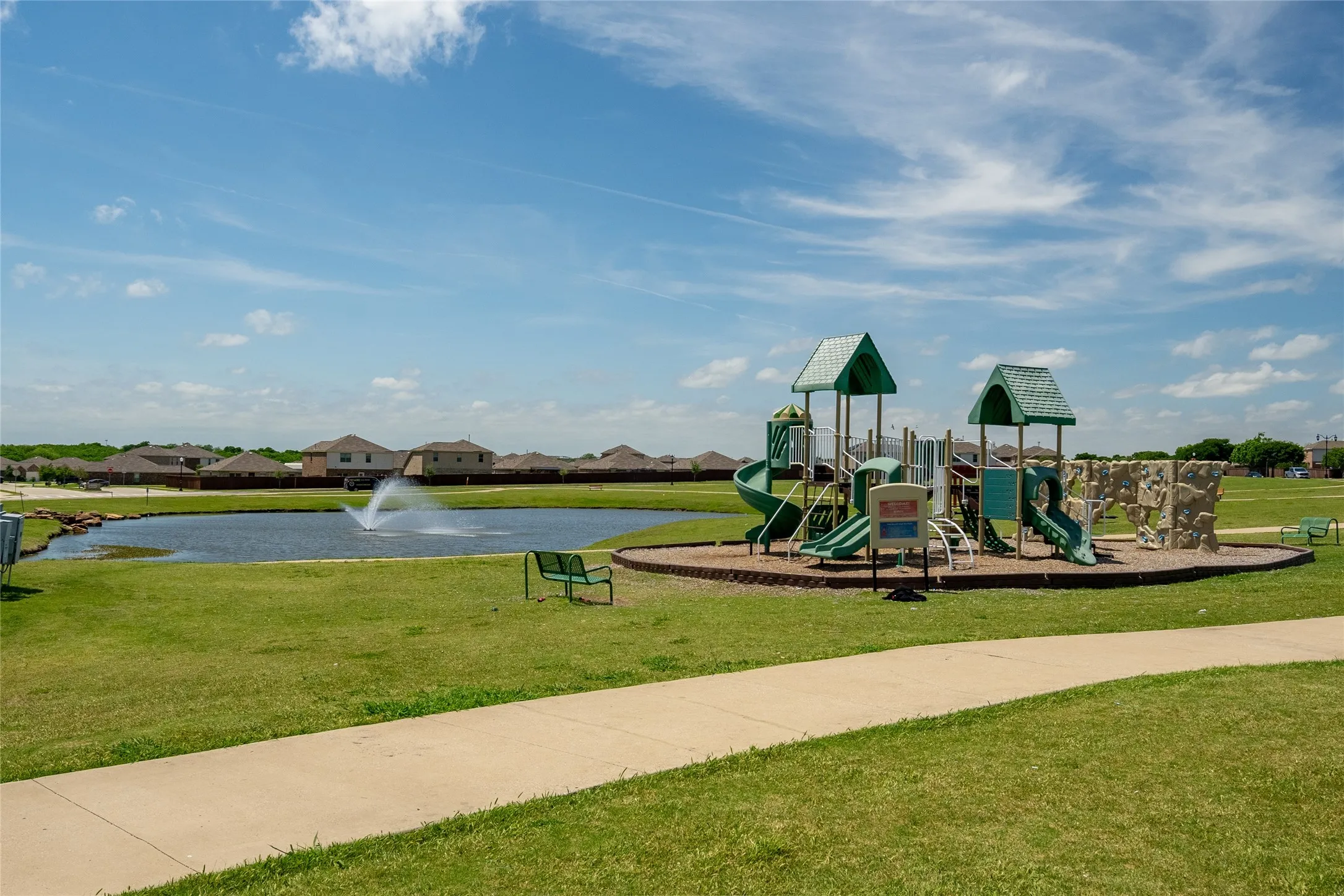View of jungle gym with a yard and a water view