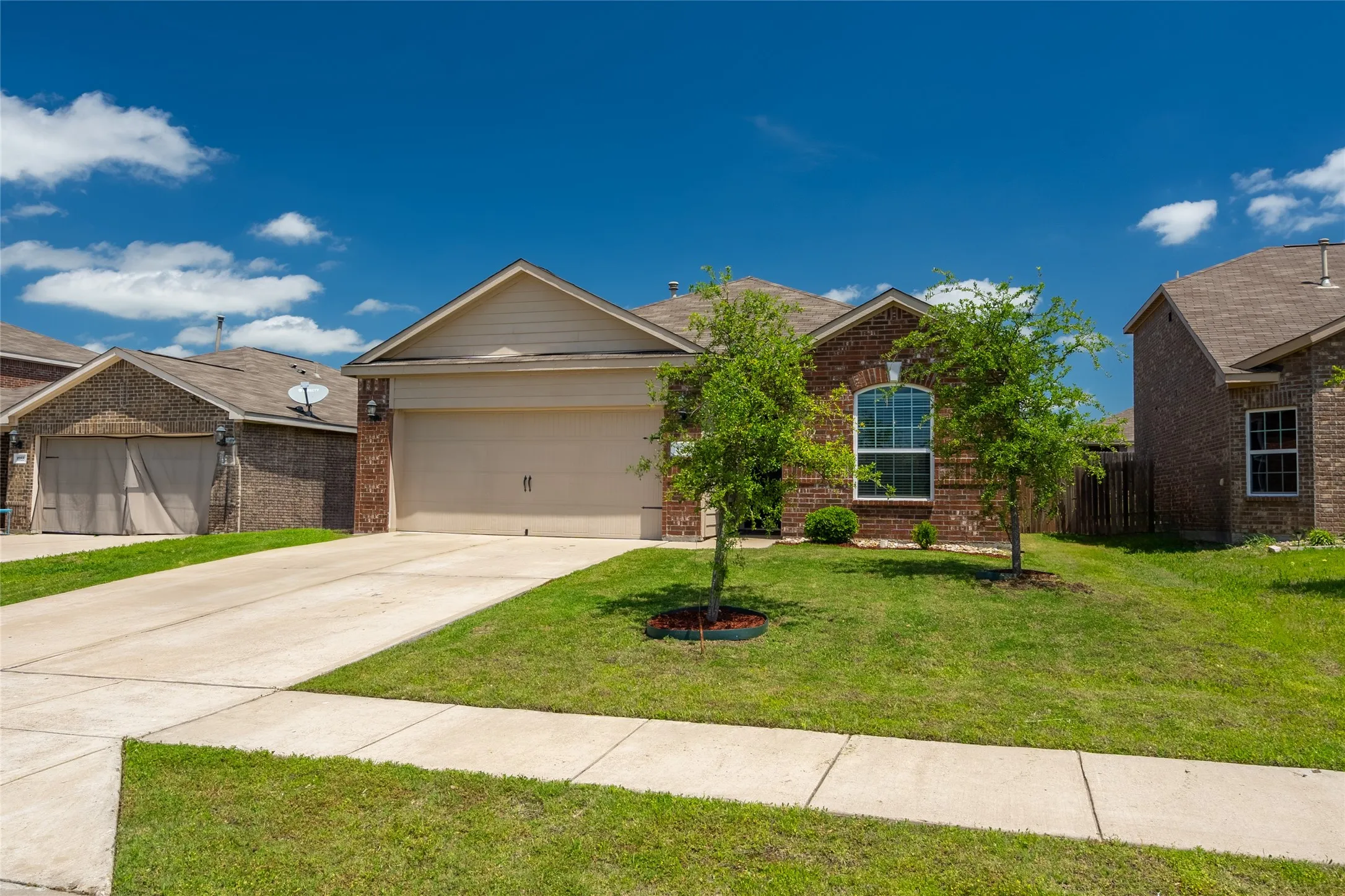 View of front of home with a front yard and a garage