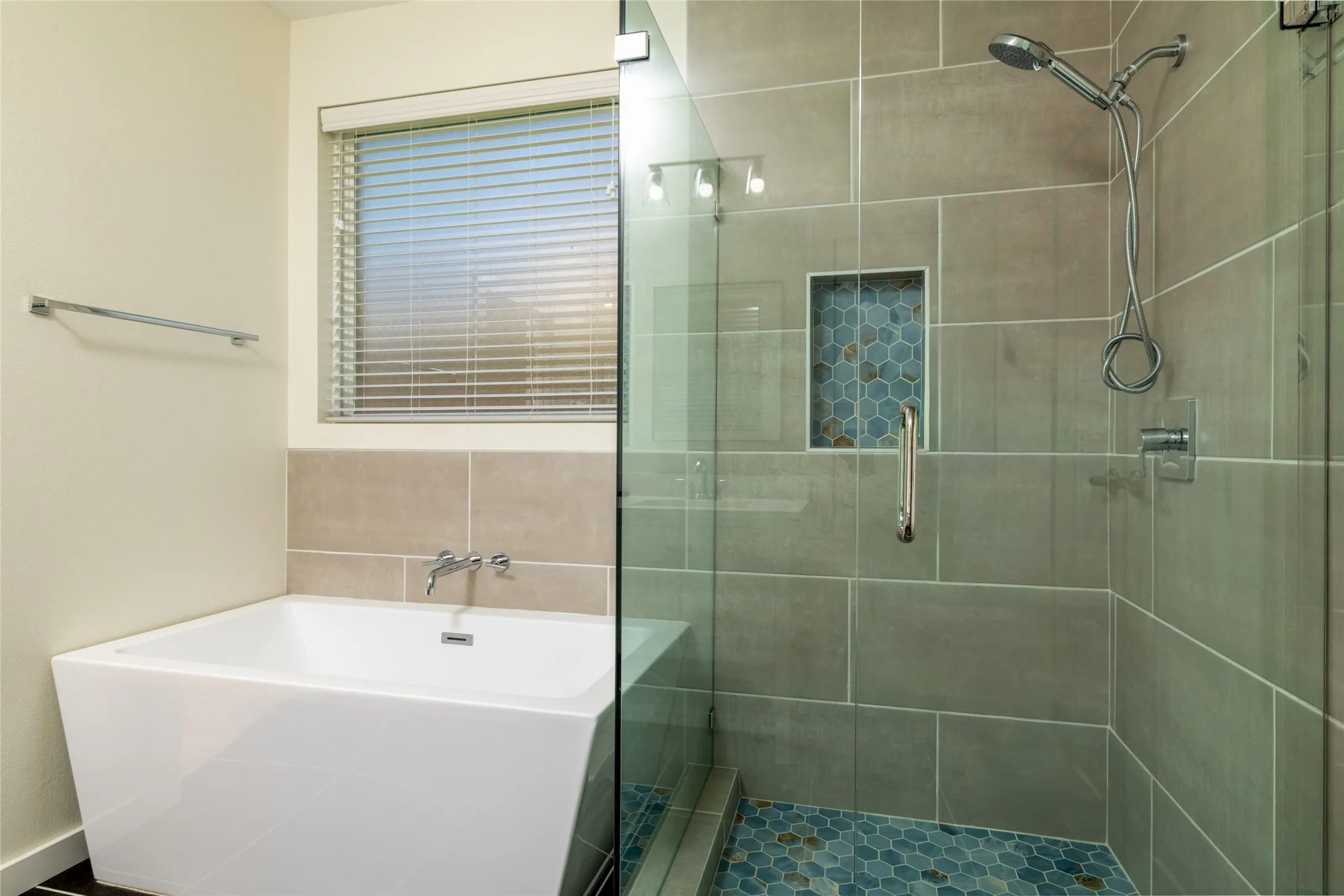 Modern bathroom featuring a freestanding soaking tub with wall-mounted fixtures