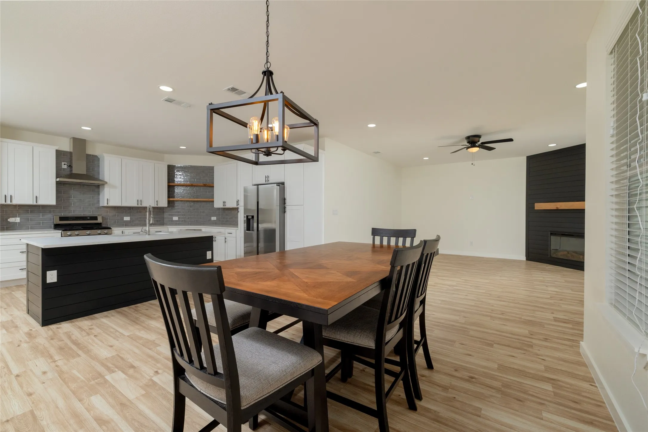 Open-concept living space featuring wood-finish flooring