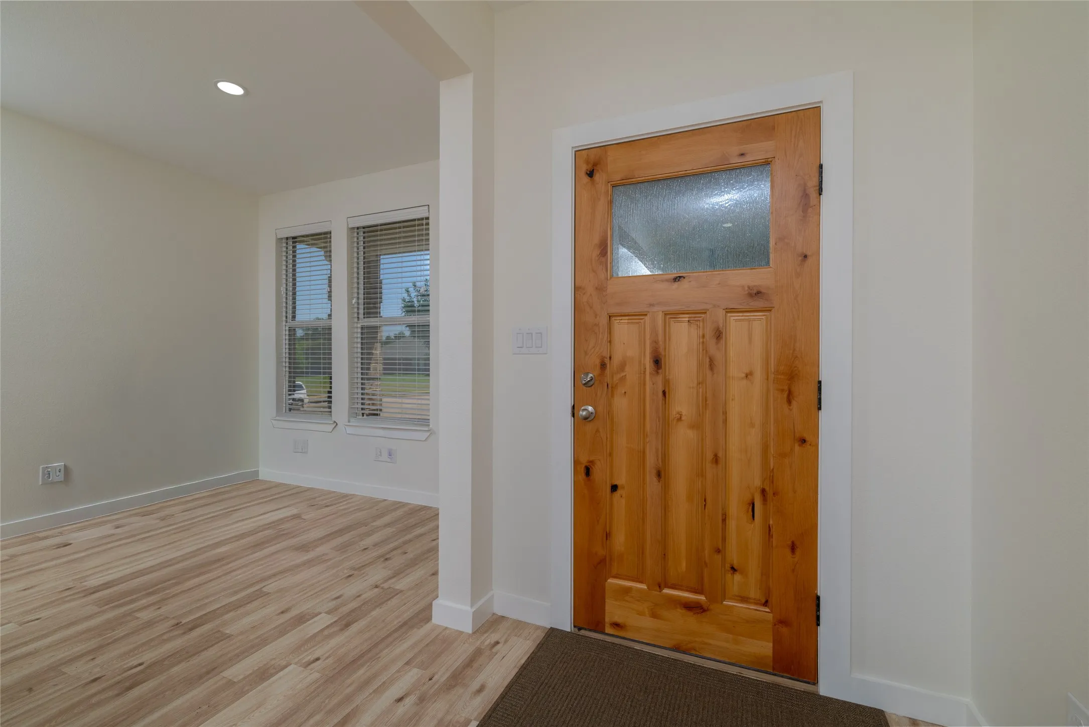 Solid wood-panel entry door with frosted glass window
