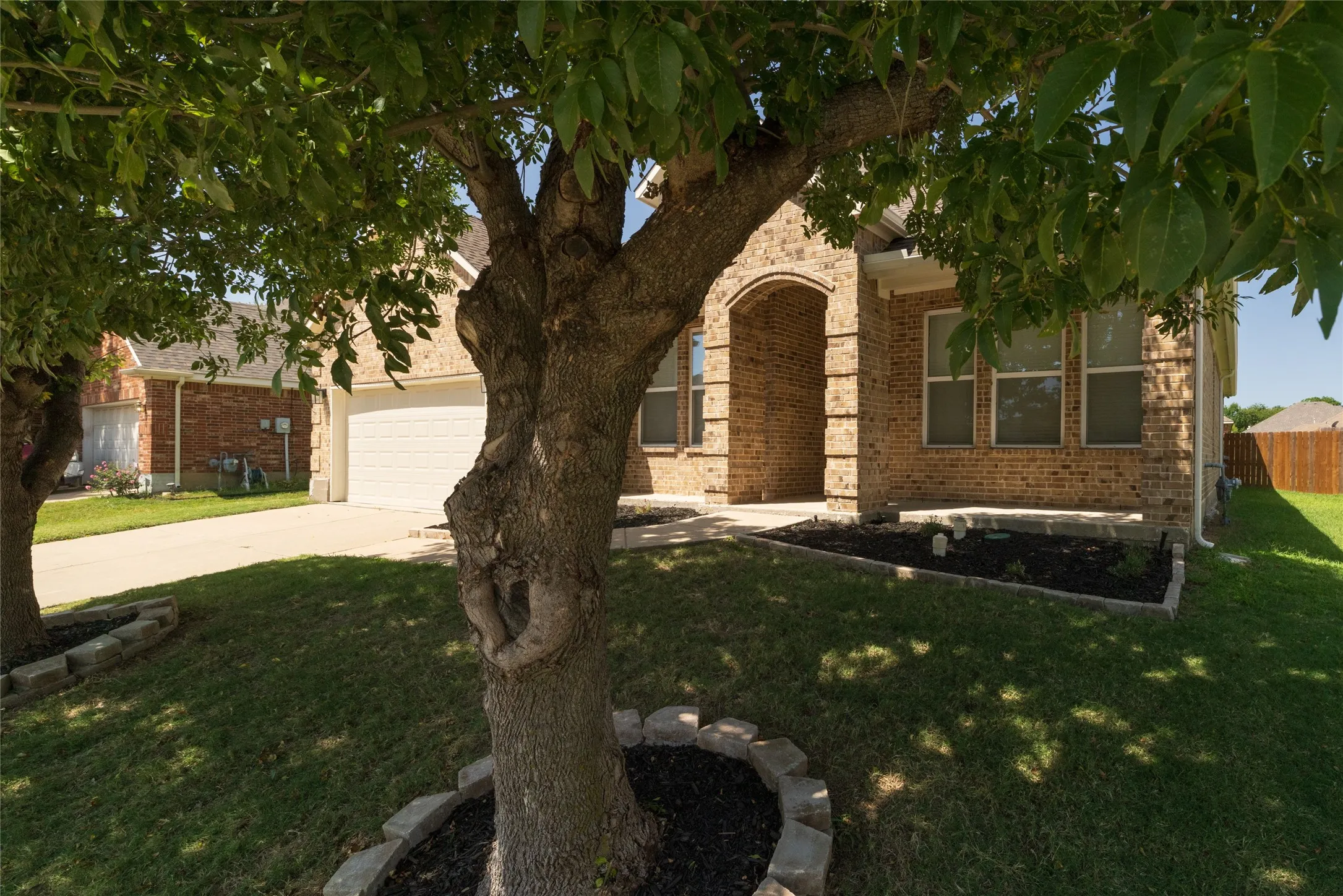 Brick exterior with an arched entry and covered porch