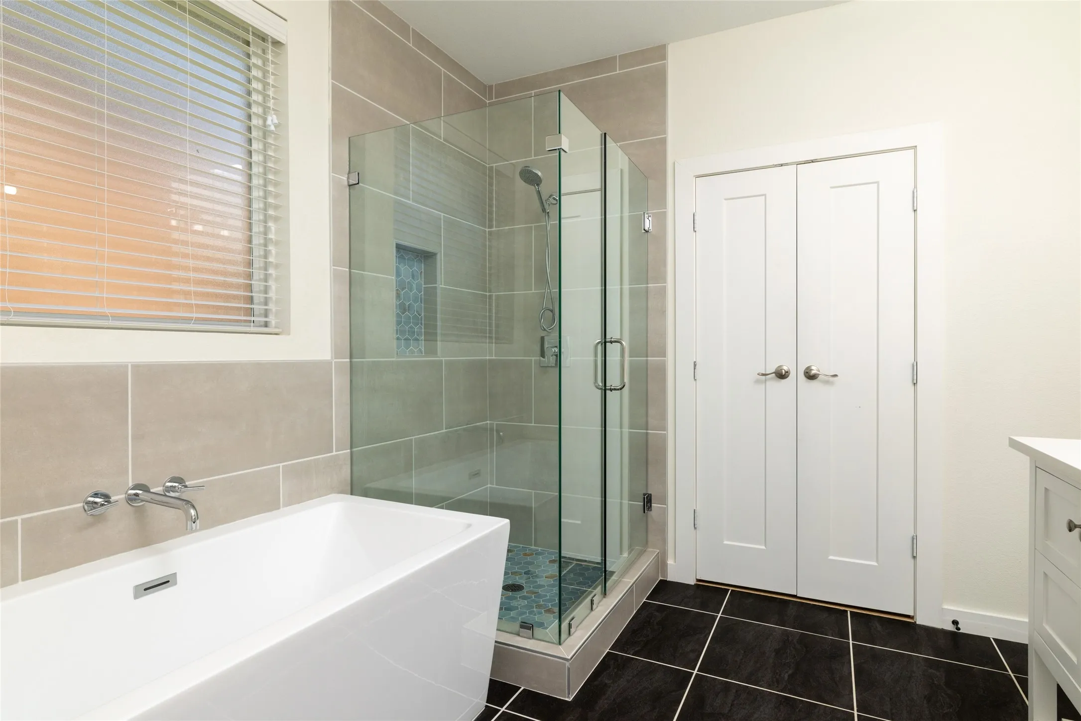 Contemporary bathroom featuring a freestanding soaking tub with wall-mounted fixtures