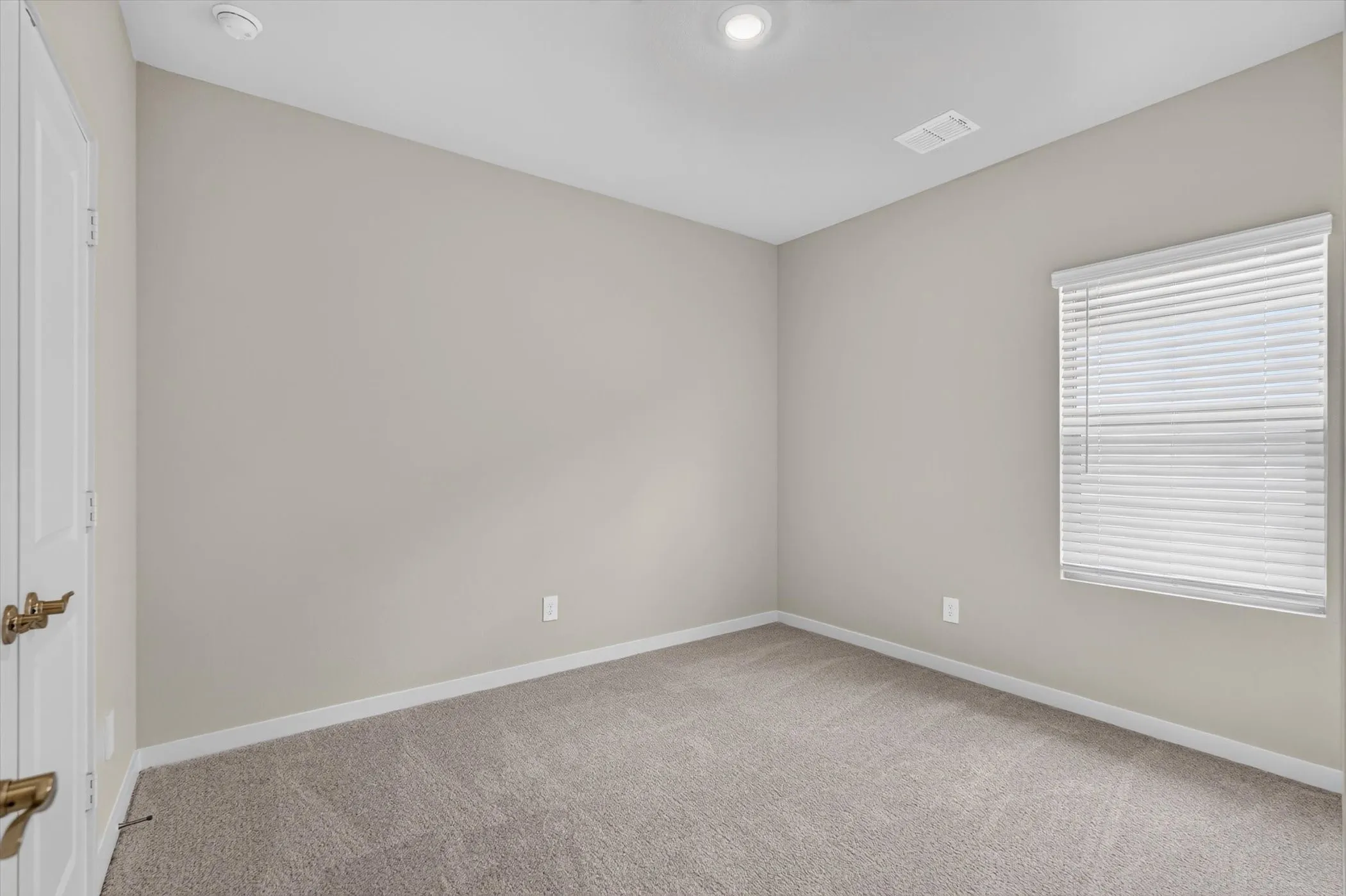 Neutral-toned walls and plush carpet flooring