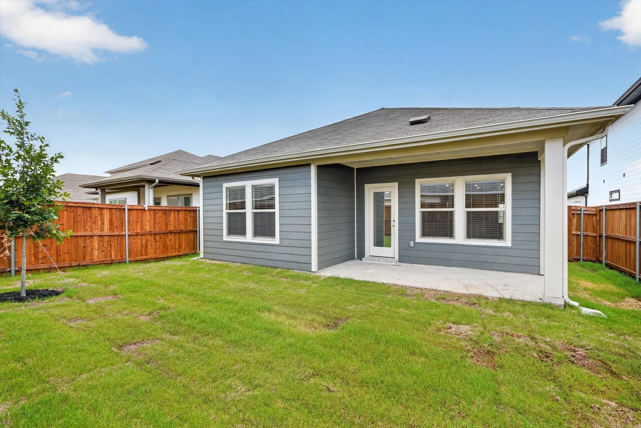 Expansive green yard with wood fencing