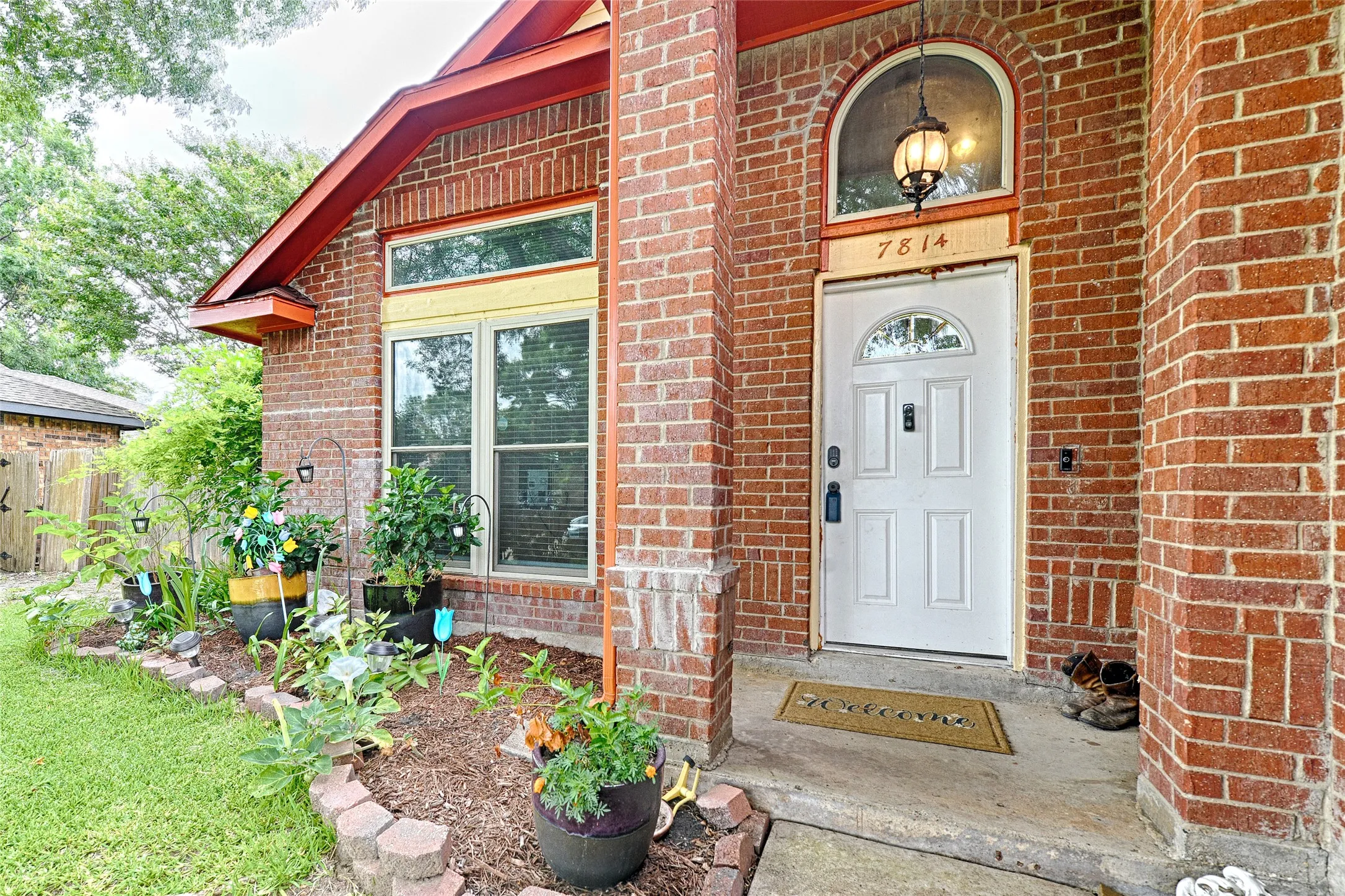 Brick exterior with an arched entry and a white paneled door