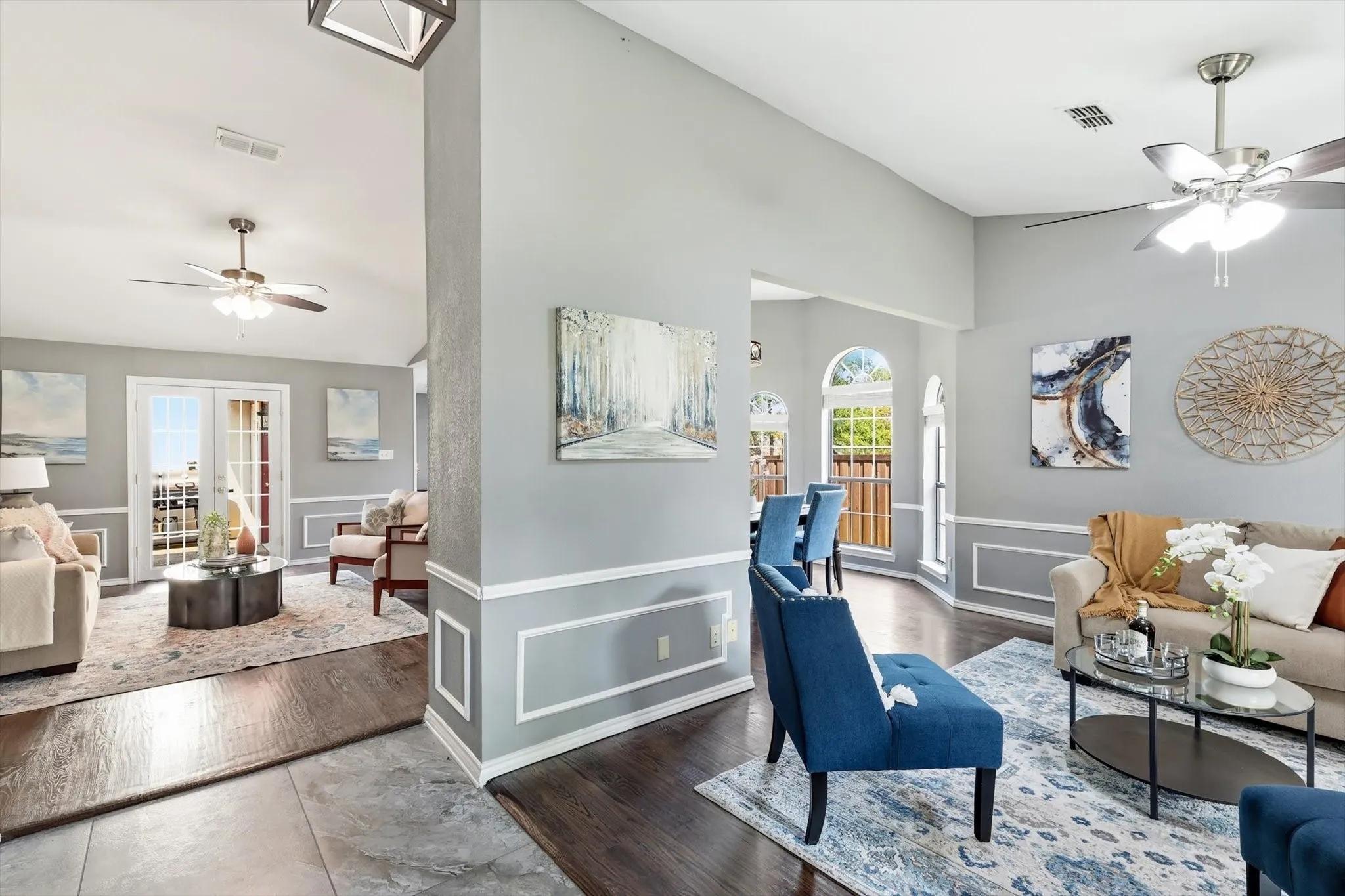 Vaulted ceilings, dark wood-finish flooring, and decorative wall molding