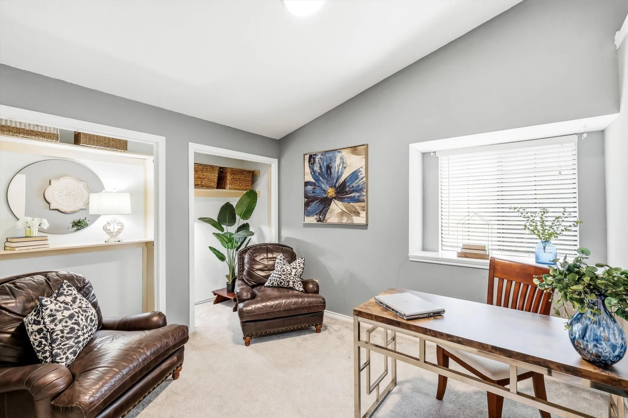 Sophisticated home office/bedroom featuring walls, recessed ceiling lighting, and large windows with horizontal blinds flooding the space with natural light