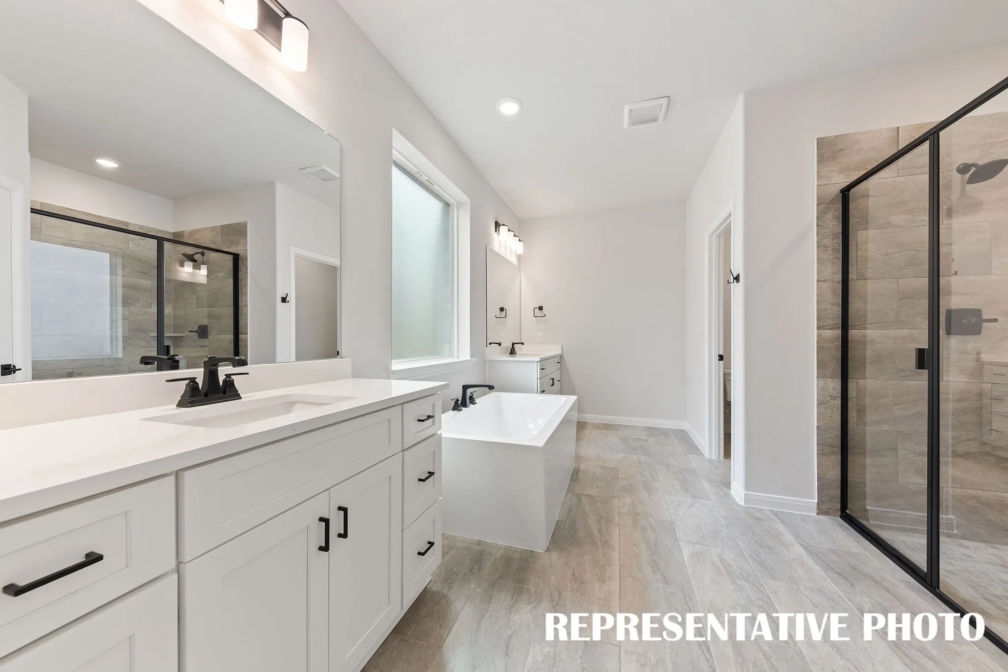 With his and her vanities and ample space for two, you'll love calling this dream bath your own!  REPRESENTATIVE PHOTO