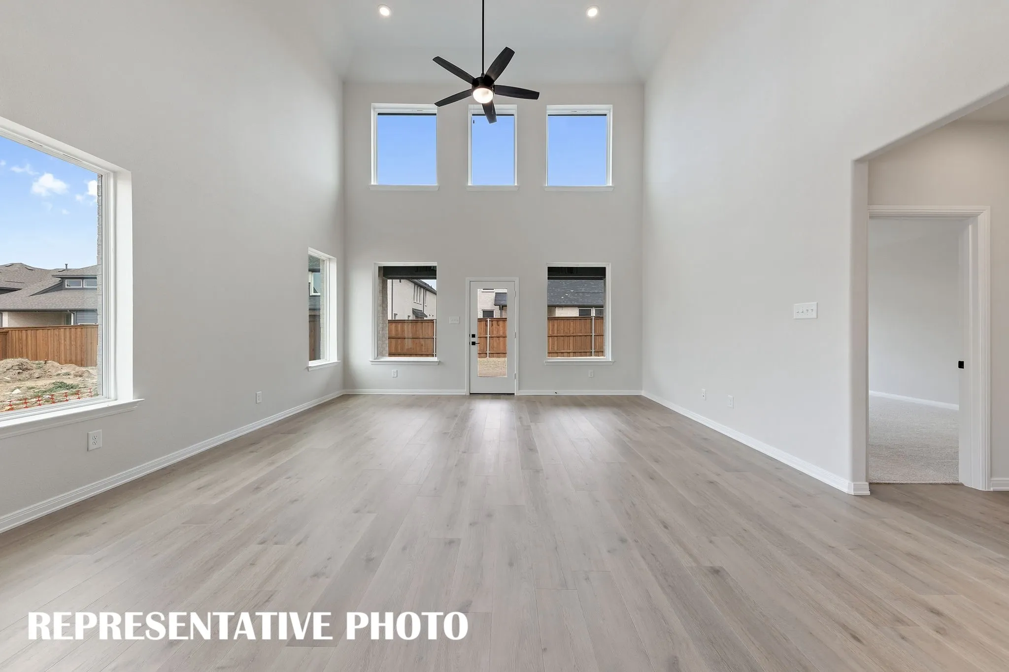 Your spacious new family room is flooded with natural light from a dual stacked wall of windows!  REPRESENTATIVE PHOTO