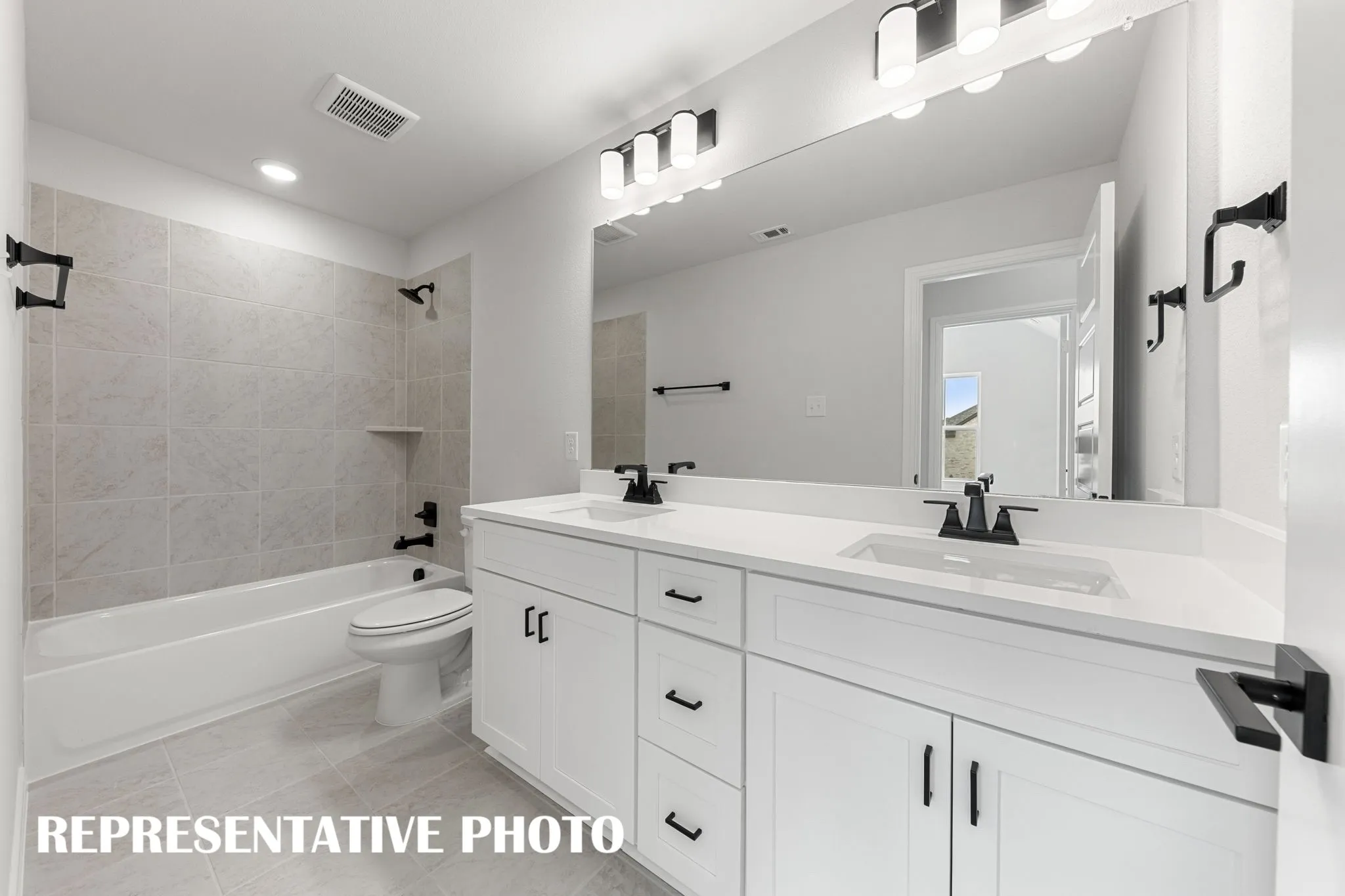 Guests will enjoy their own vanity space in this thoughtfully designed guest bath.  REPRESENTATIVE PHOTO