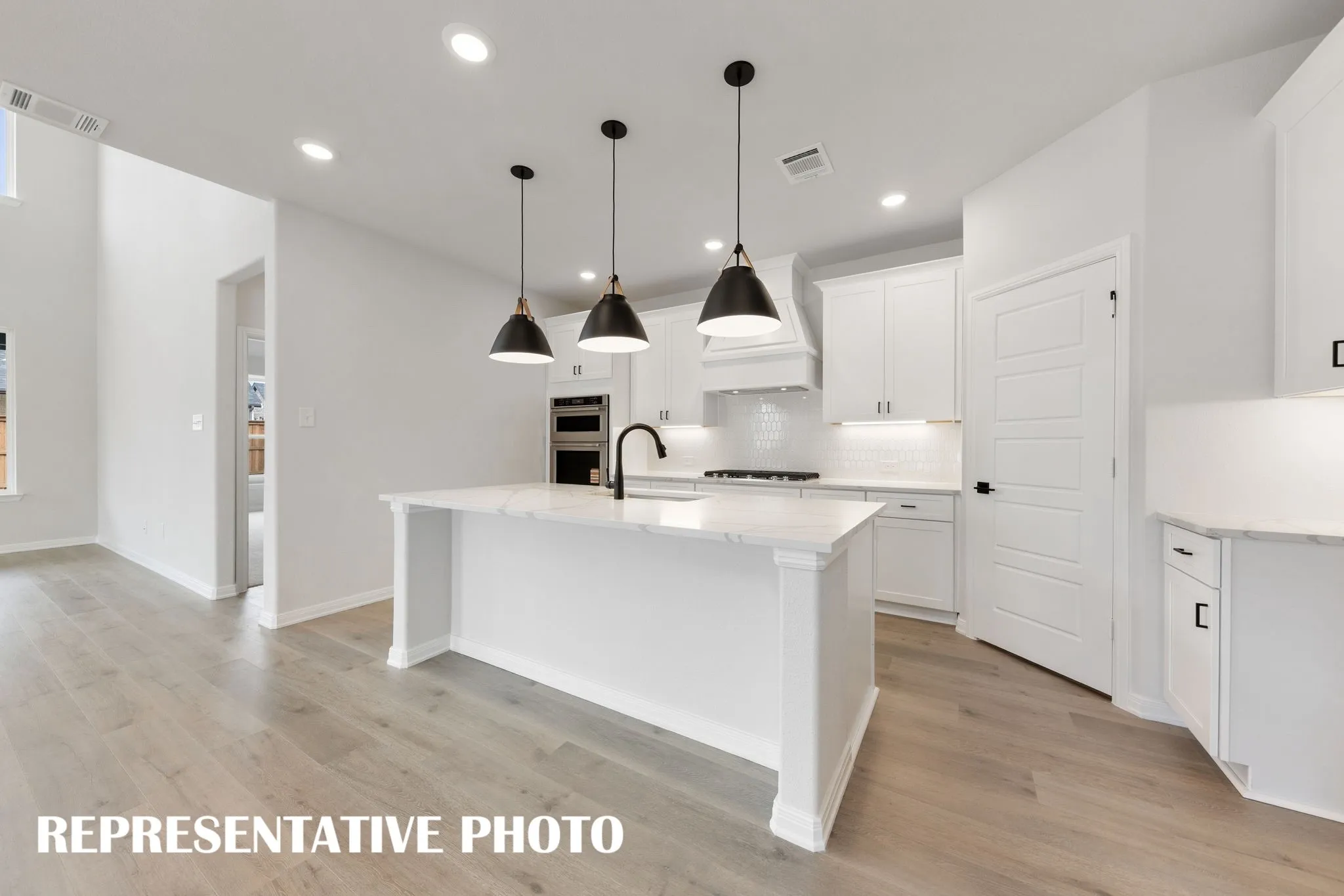 Featuring a spacious kitchen island that overlooks the family and dining rooms, the chef in the family will never be left out of the party in this dream kitchen!  REPRESENTATIVE PHOTO