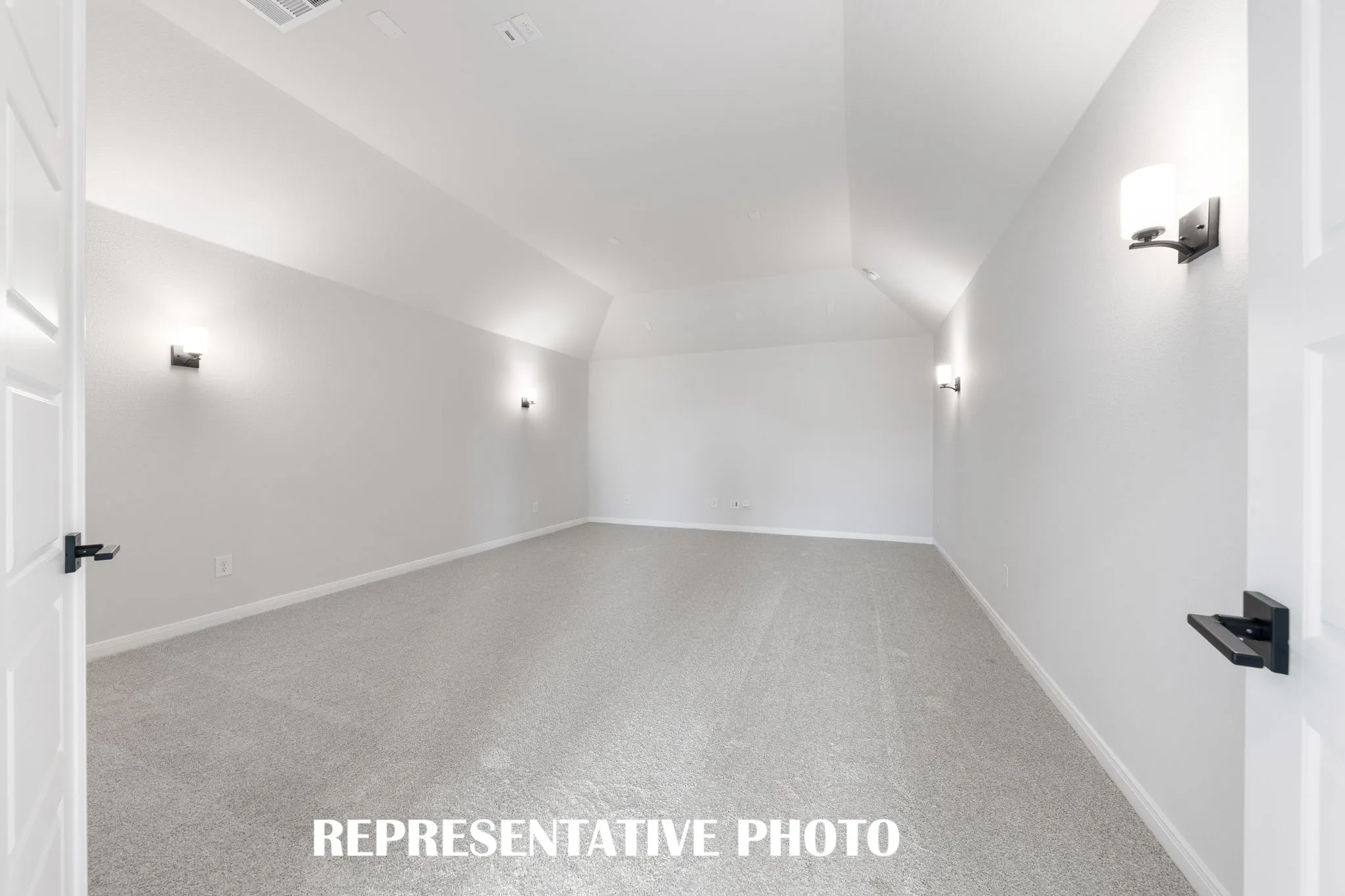 This spacious media room with adjacent game room create the ultimate family entertainment zone!  REPRESENTATIVE PHOTO