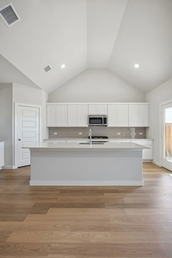 Kitchen in the Wimbledon home plan by Trophy Signature Homes – REPRESENTATIVE PHOTO