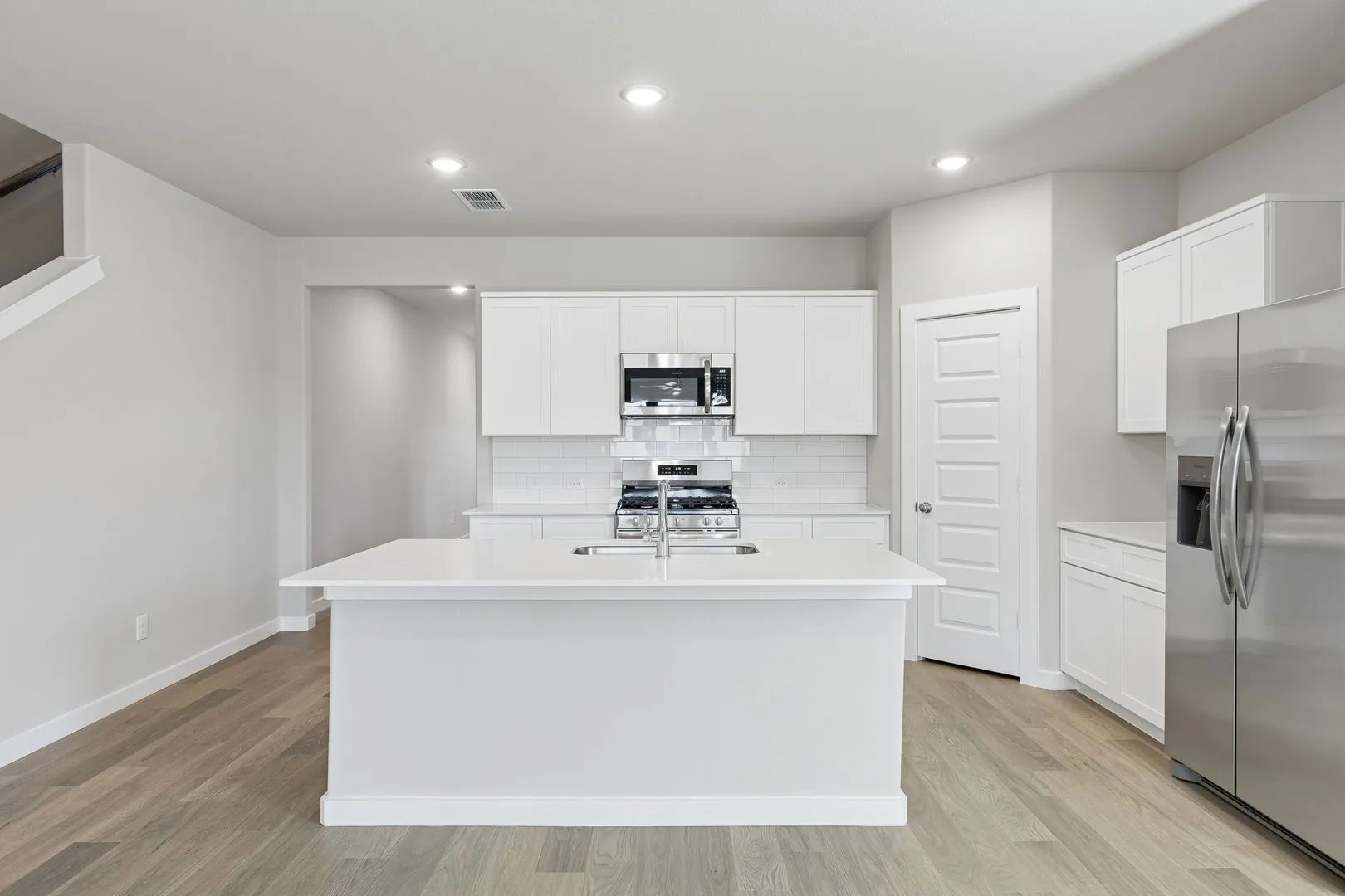 Kitchen in the Holden home plan by Trophy Signature Homes – REPRESENTATIVE PHOTO
