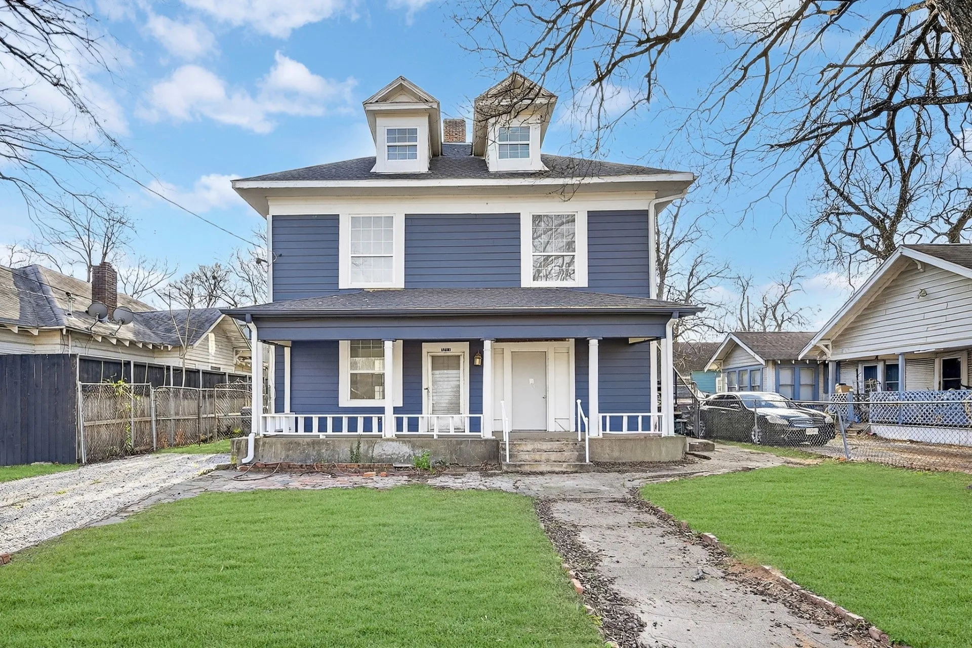 Two-story residence featuring blue siding with white trim