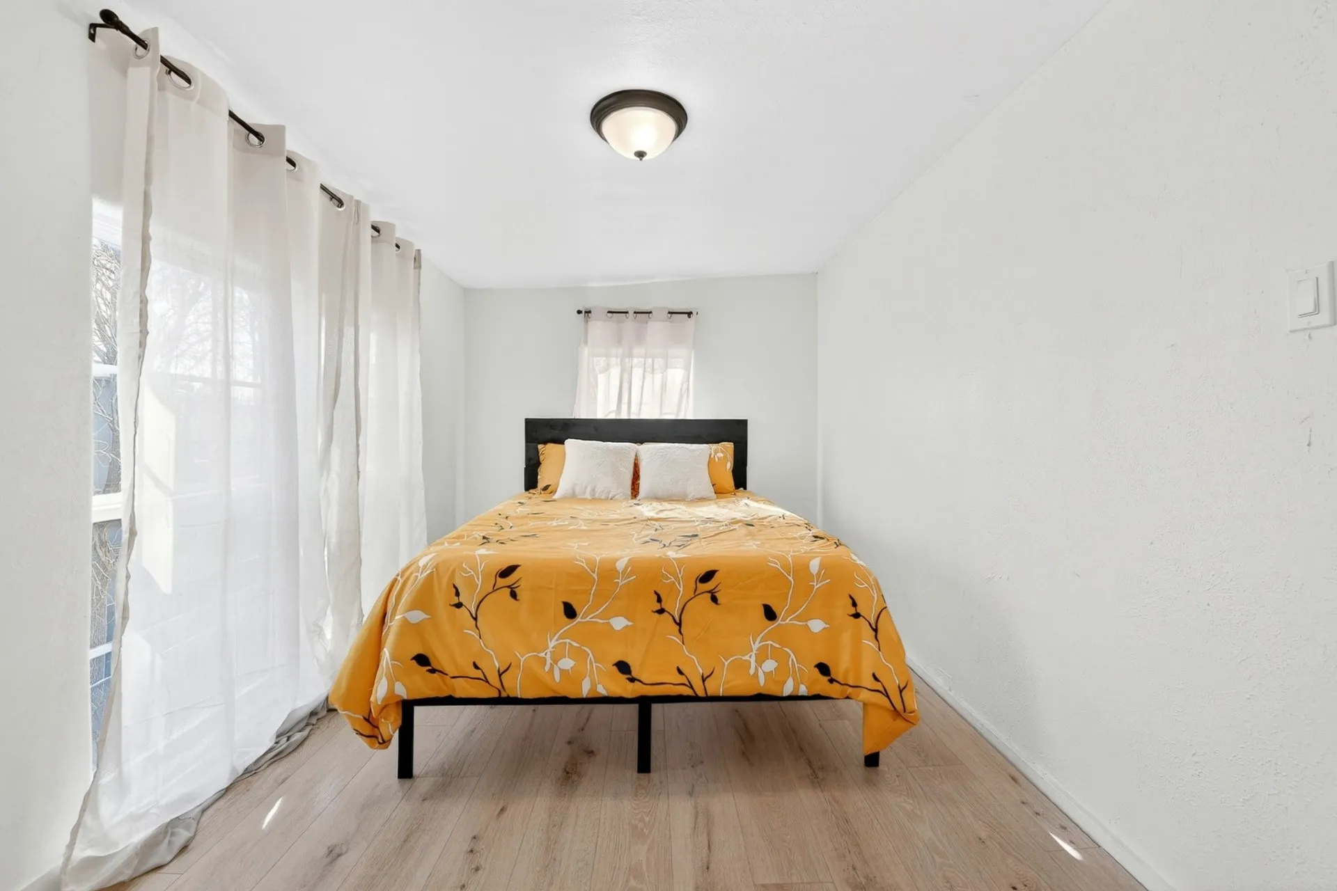 Room featuring light wood-finish flooring, white walls, and a white ceiling