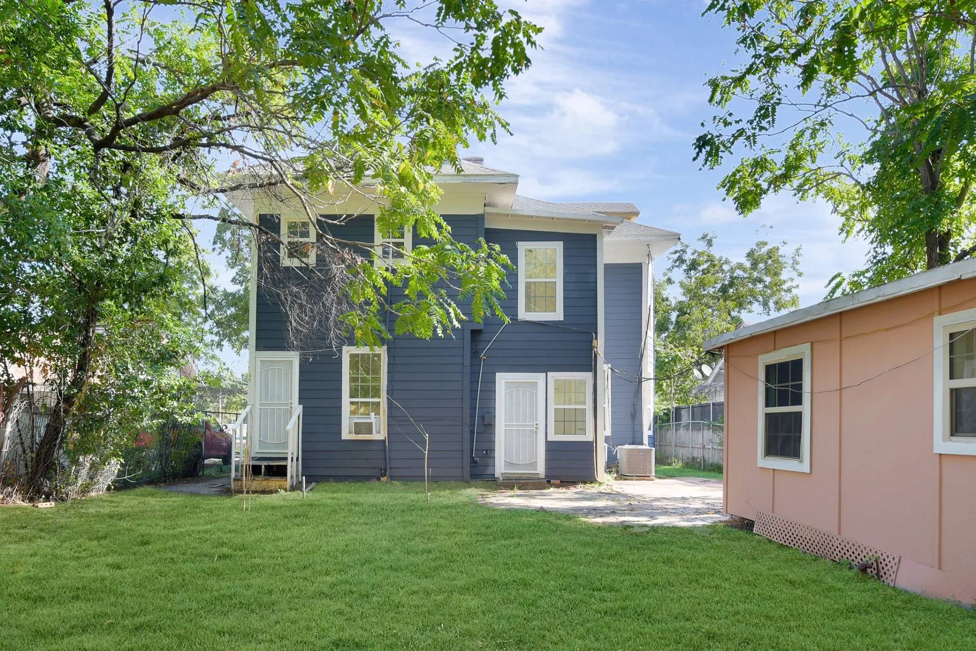 Two-story residence featuring blue siding and white window trim