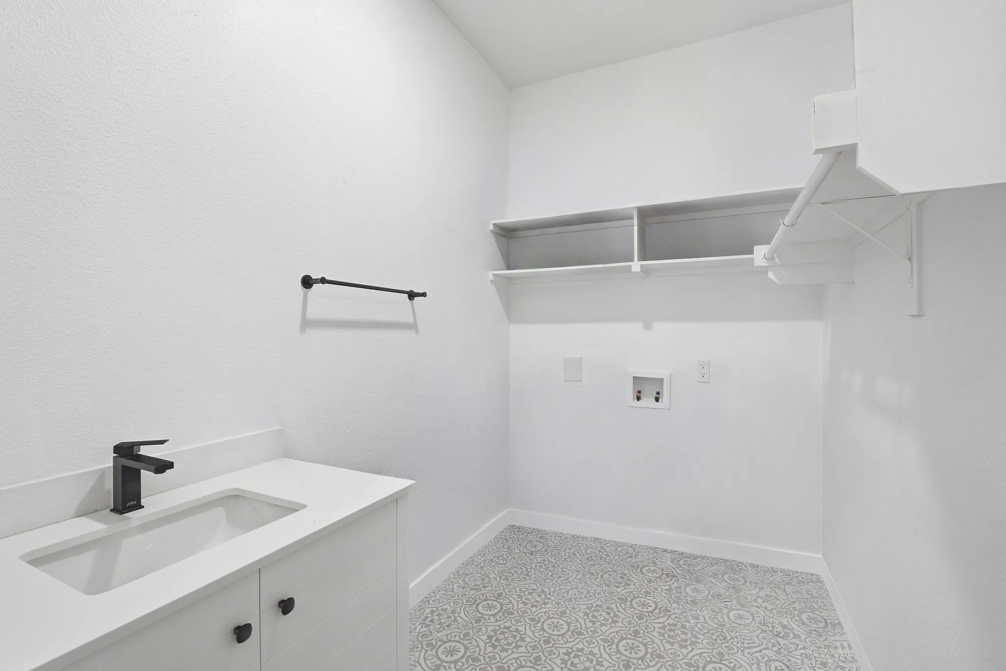 Laundry Room With Sink And Designer Tile Flooring.
