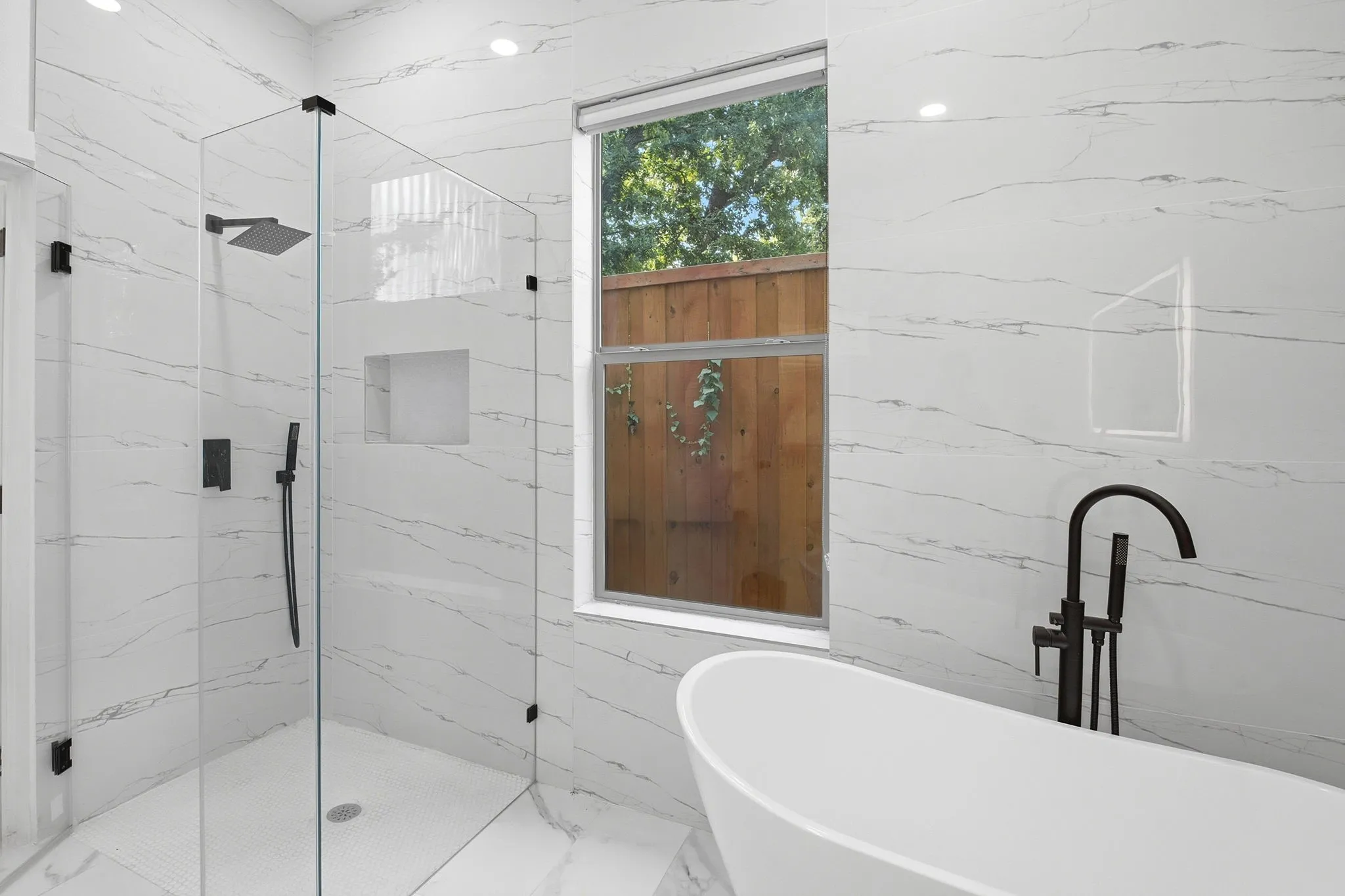 1st Floor Primary Bedroom Ensuite Showcasing Free Standing Tub and Shower.