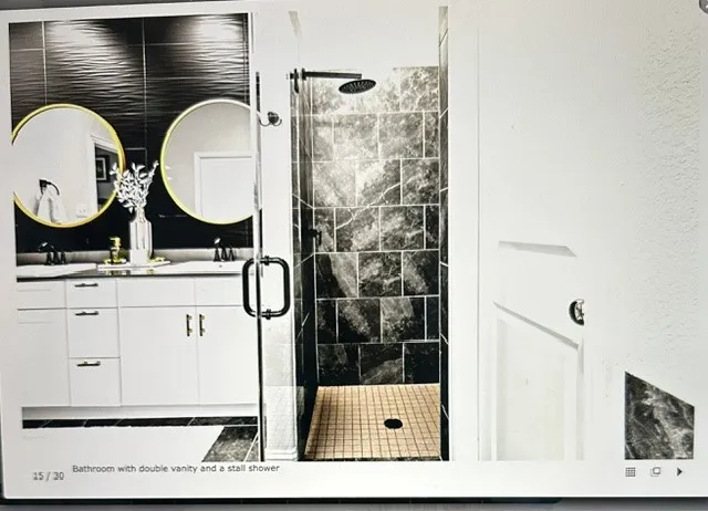Double vanity with undermount sinks and contemporary gold-framed circular mirrors