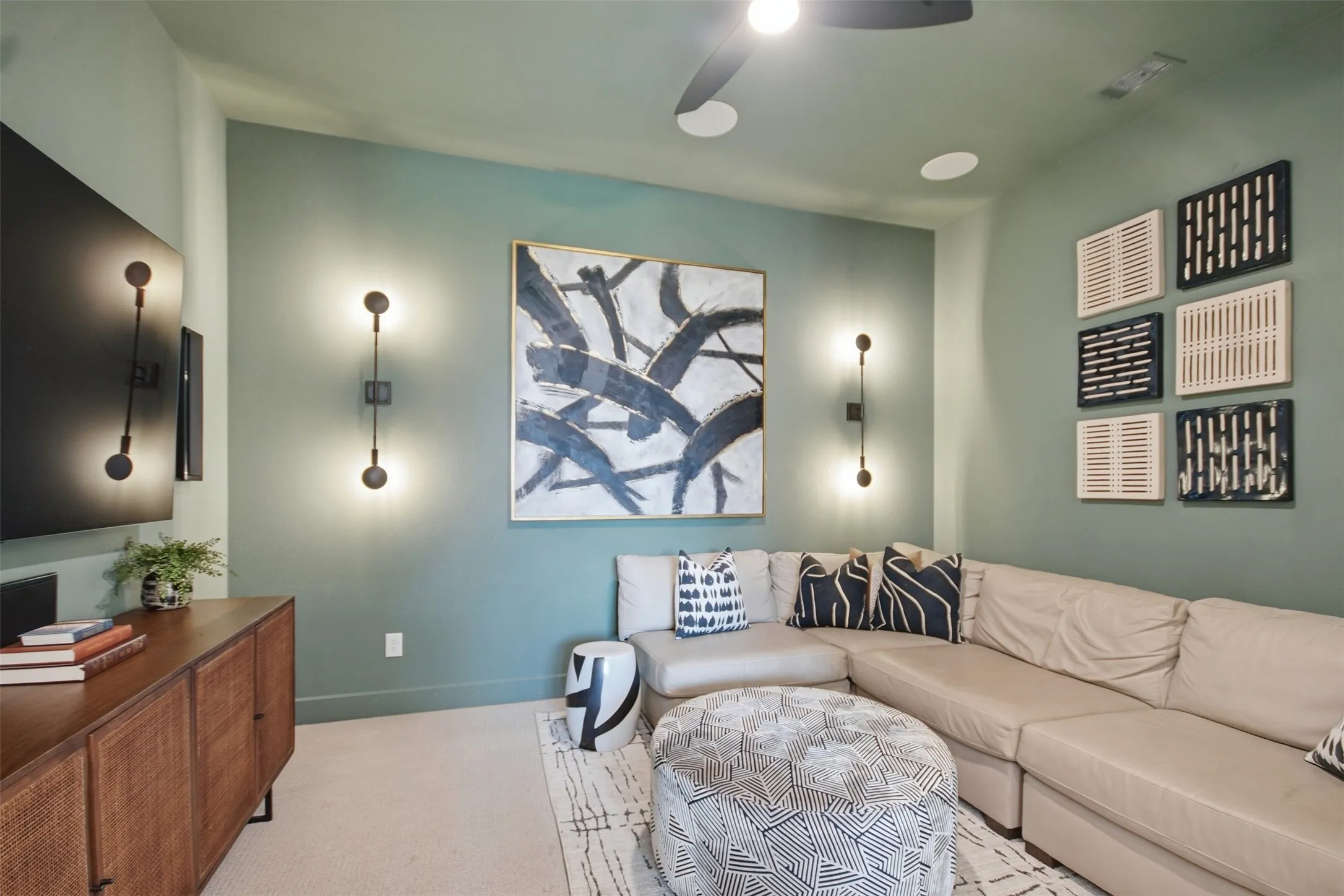 Spacious room featuring light green walls and carpet flooring
