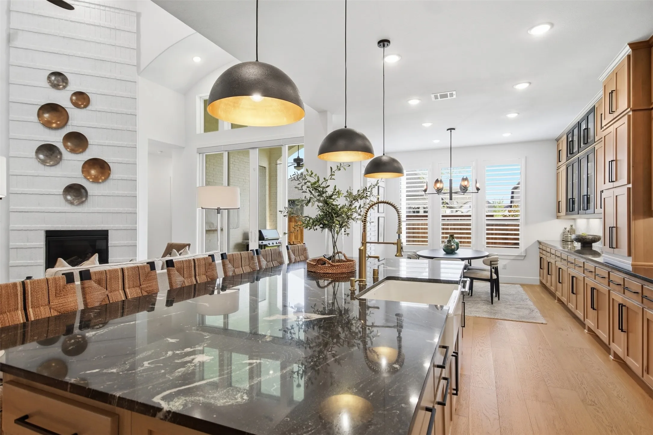 Expansive kitchen island with a dark stone countertop and integrated sink
