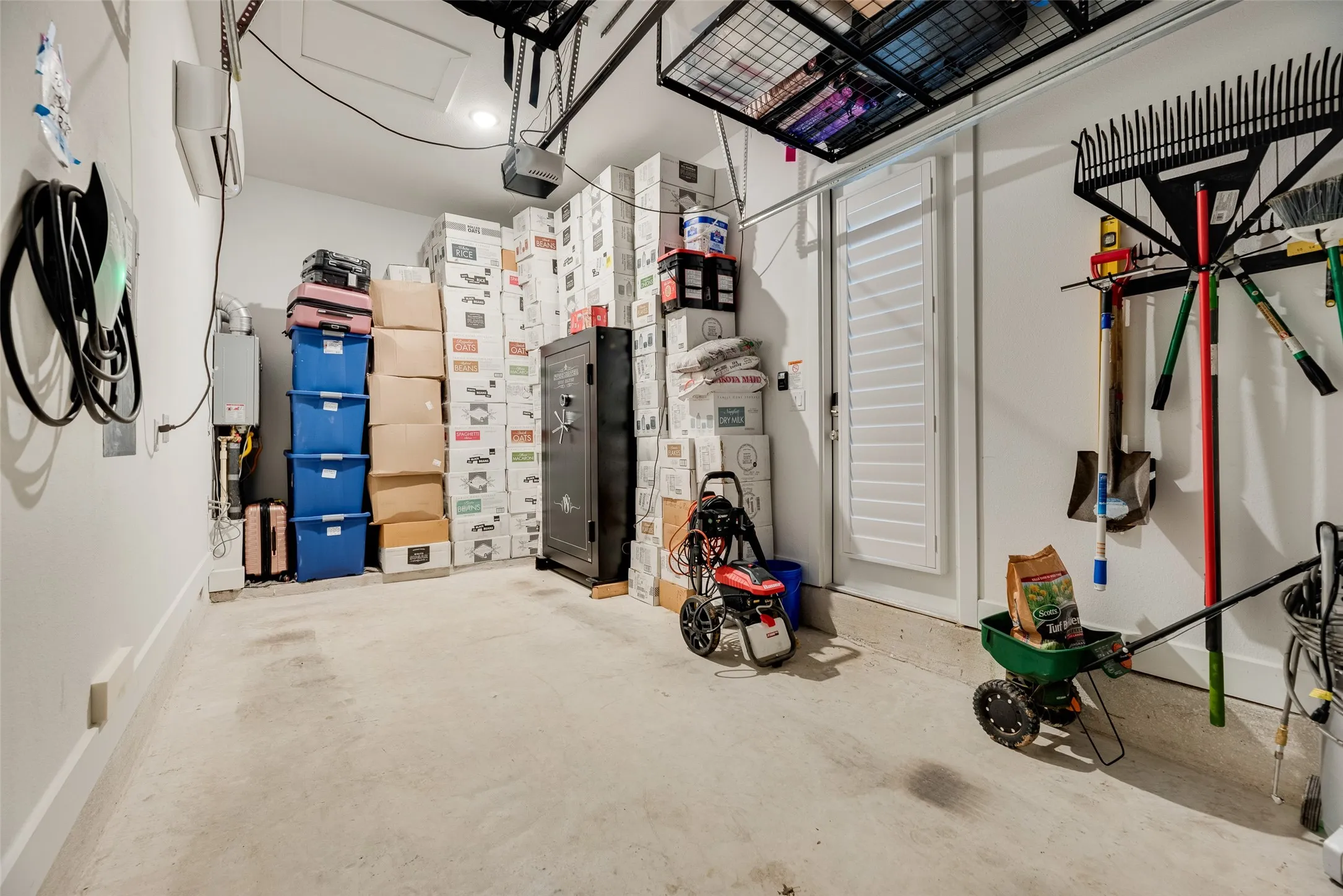 AC Garage including a vehicle charging station and storage racks. Ideal space for gym and extra storage that needs AC.