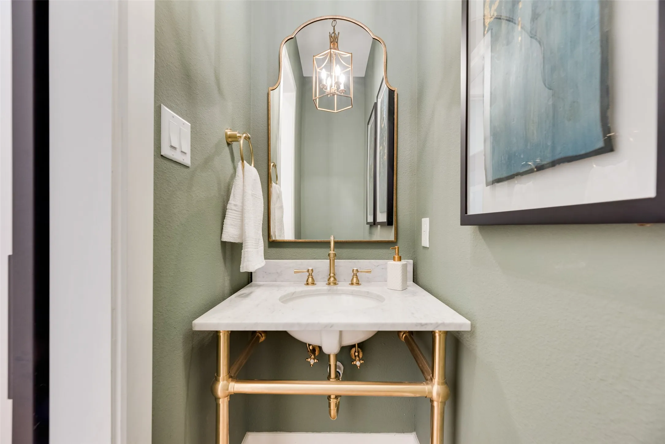 Downstairs - Pedestal vanity with a stone countertop and an undermount sink