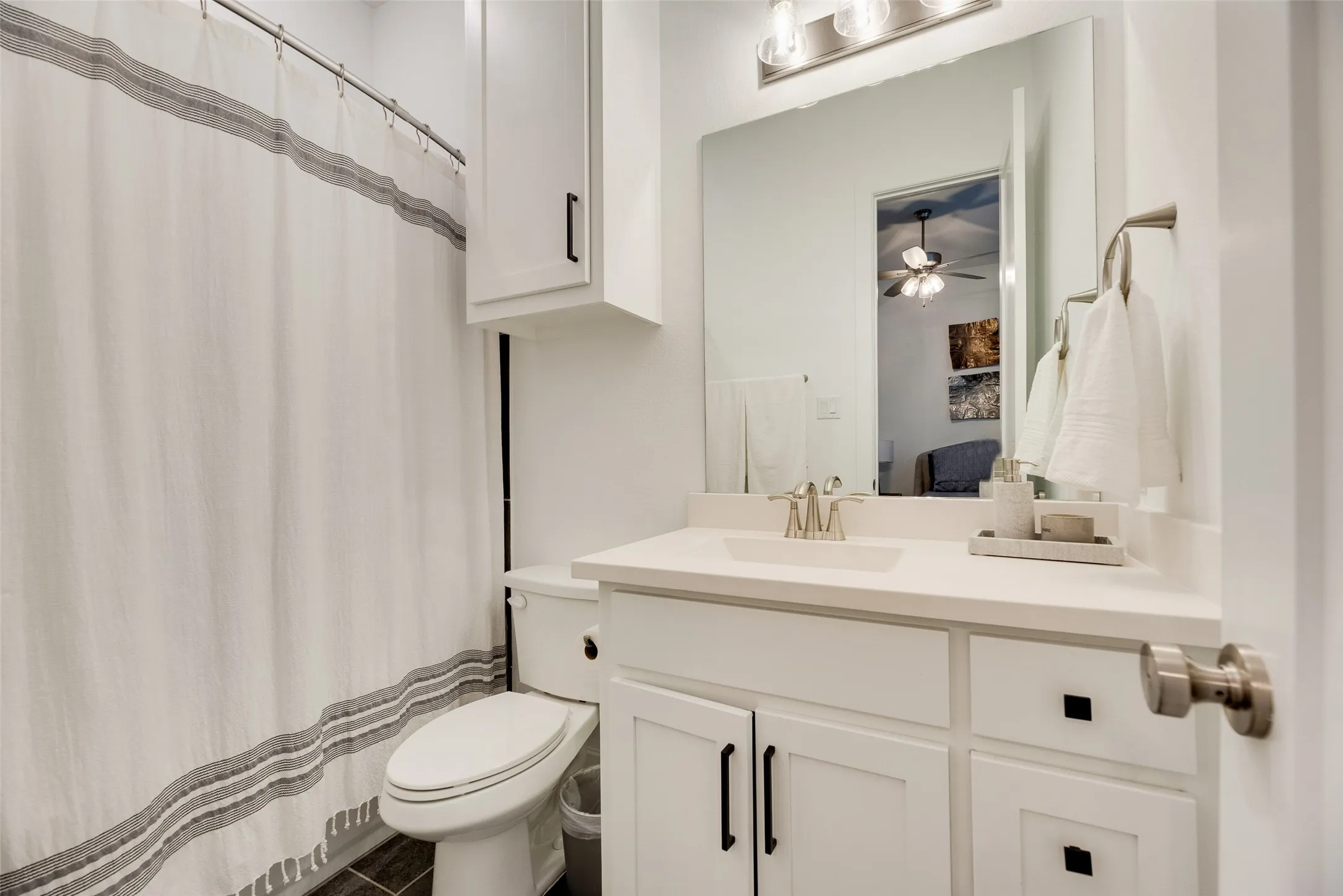 Bedroom 2 - Ensuite bathroom Vanity with integrated sink, white countertop, and brushed nickel faucet