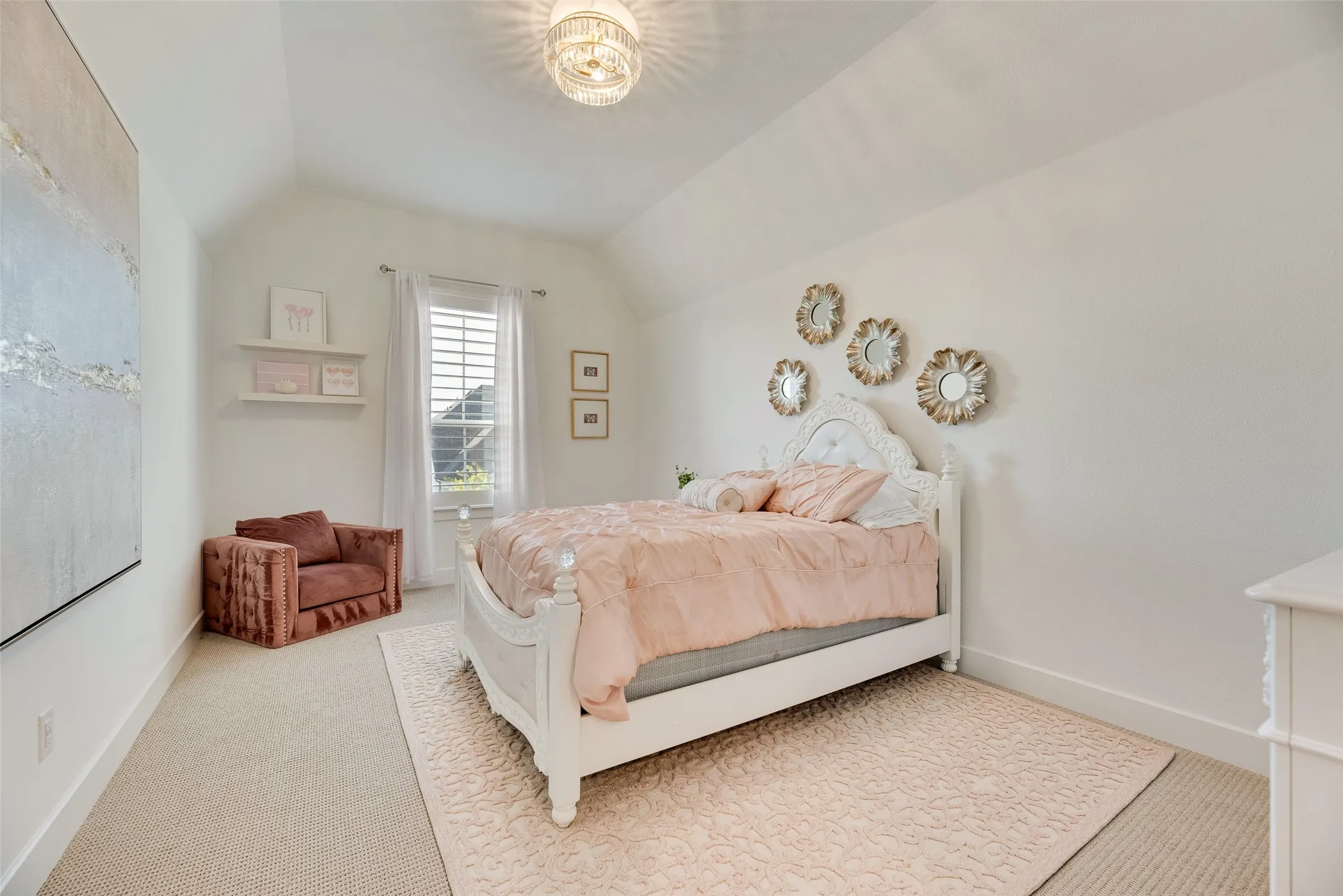 Vaulted ceiling room featuring light-colored carpet, a window with plantation shutters, and a decorative ceiling light fixture