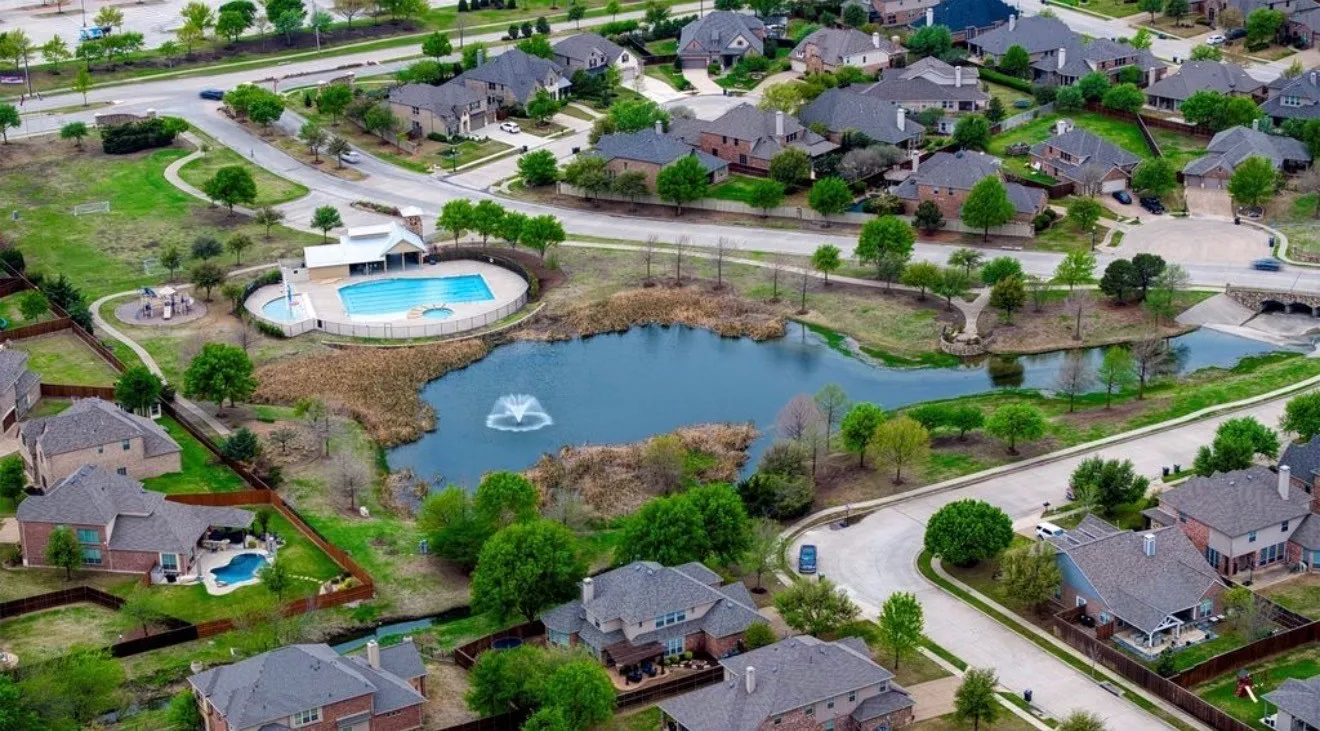 Community amenities featuring a central pond with fountain, a swimming pool, and a dedicated clubhouse structure