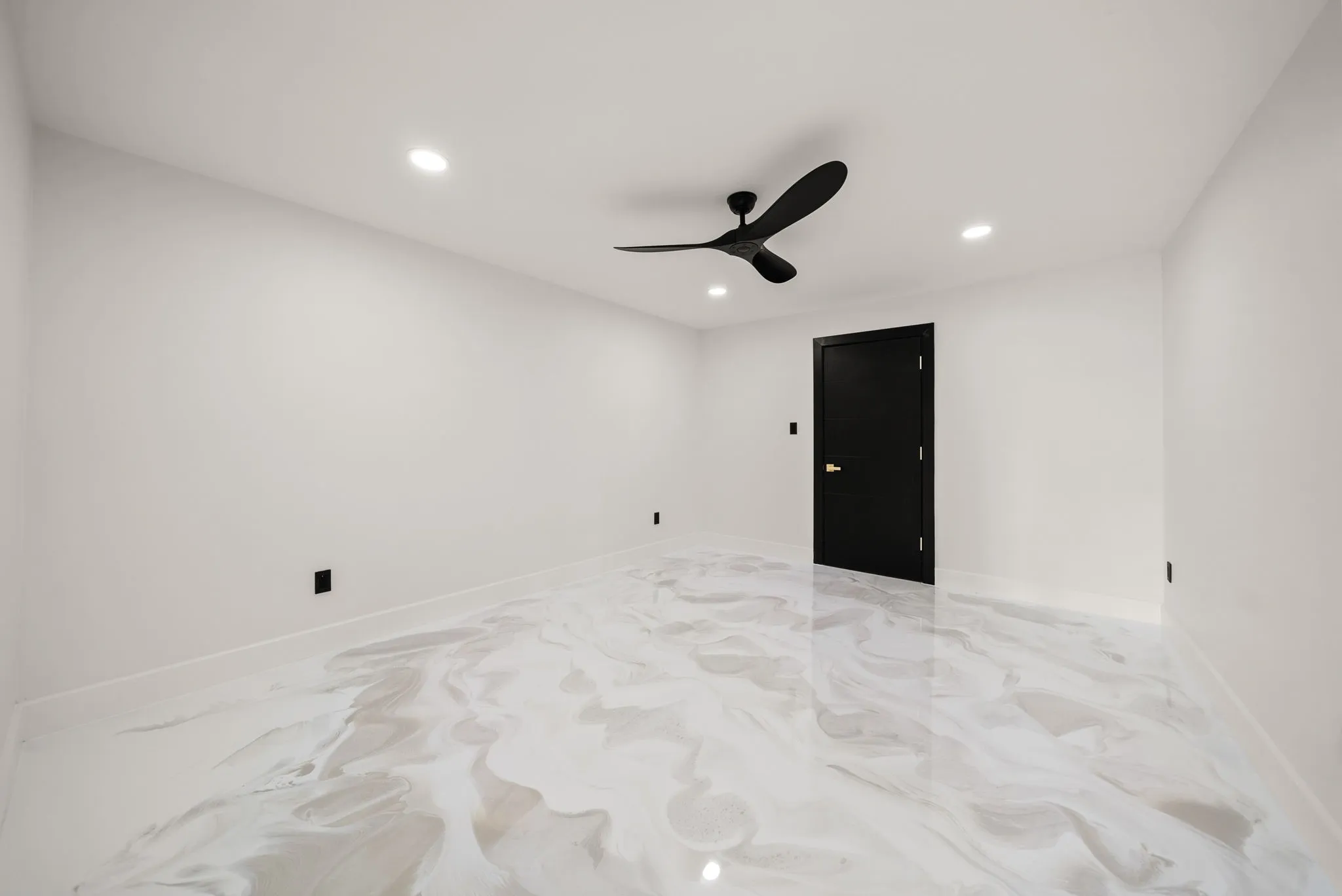 Spacious room with white walls and a glossy, marbled-effect flooring