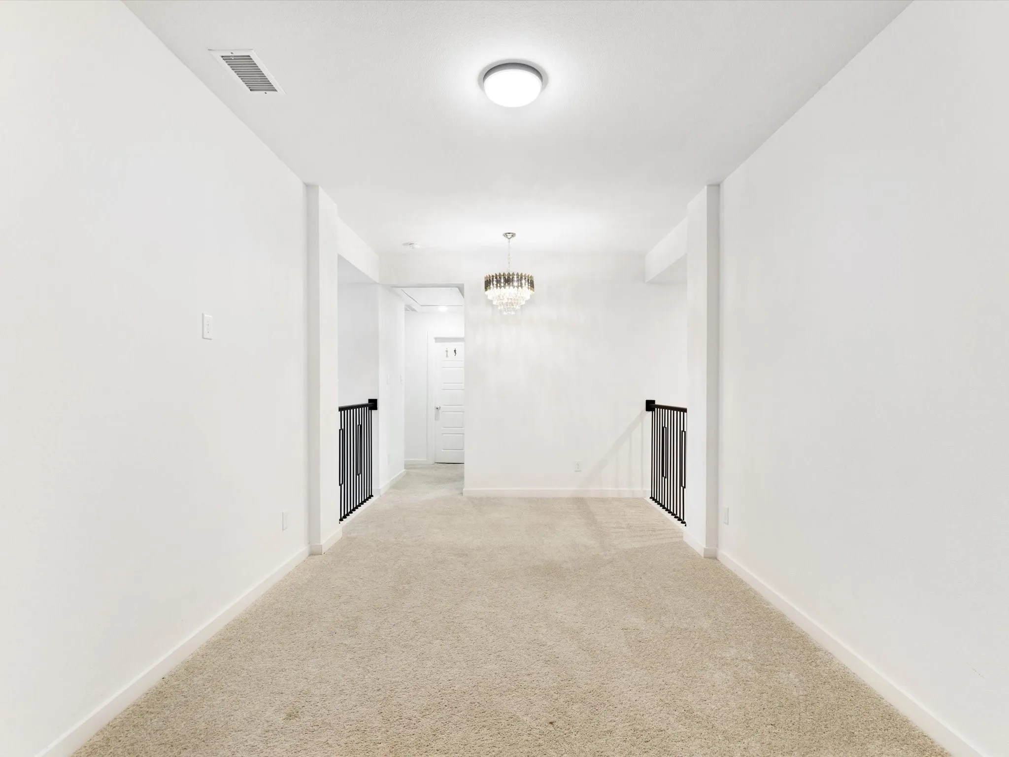 Carpeted game room with a central chandelier light fixture