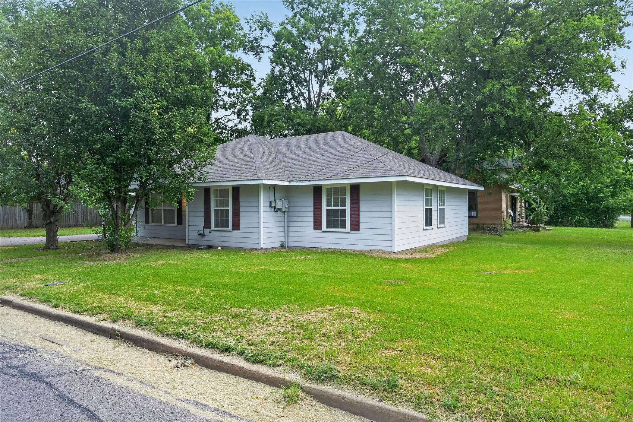 Light-colored siding exterior with a dark shingle roof
