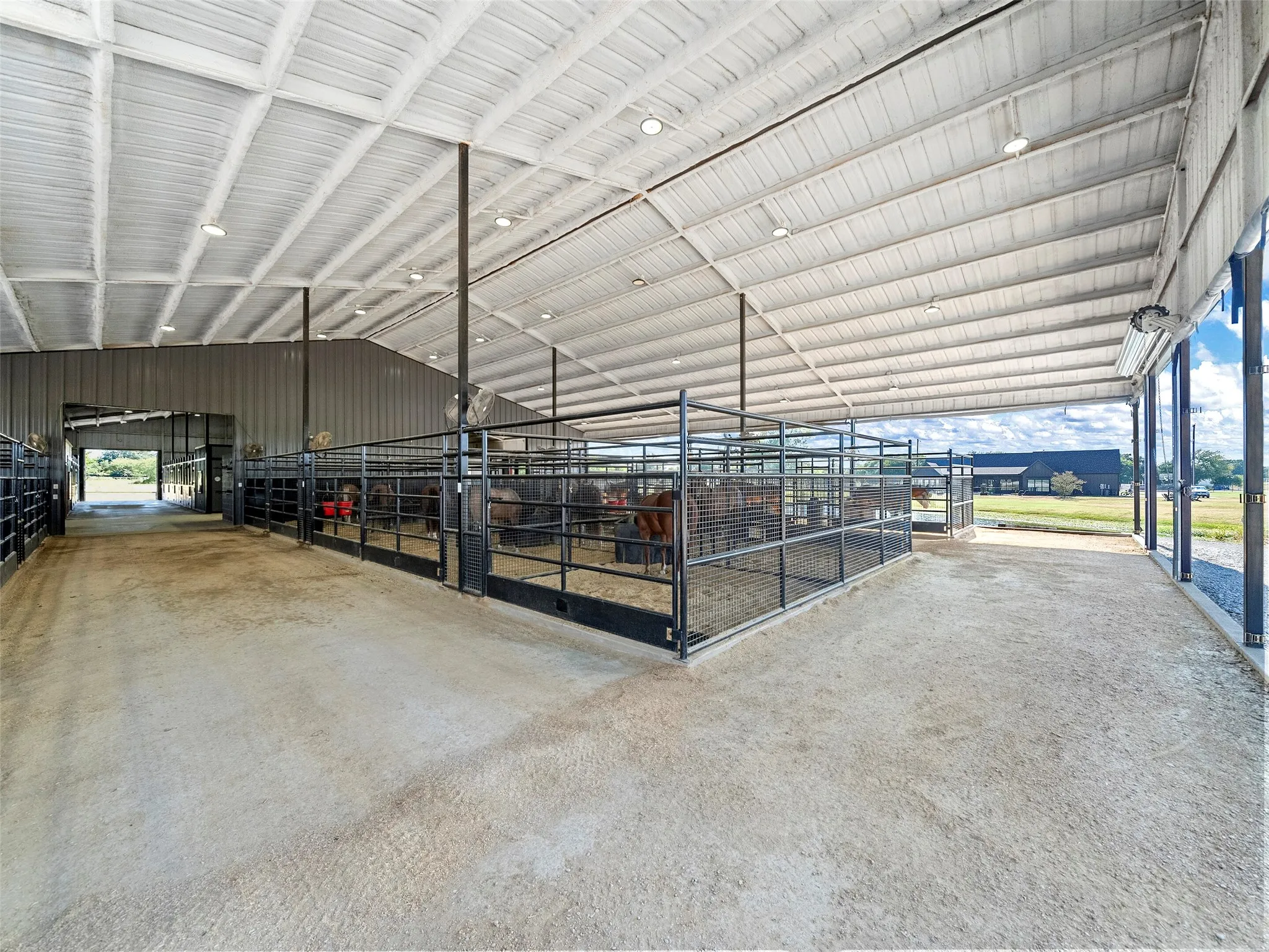 MAIN BARN MARE MOTEL STALLS...20 (12x12) Welded Wire Stalls W/Auto Waterers, Corner Feeders, Stall Mats, Fly System, Wind Screens On 3 Sides Of Bldg, Insulated Roof, Direct Access Into Show Barn
