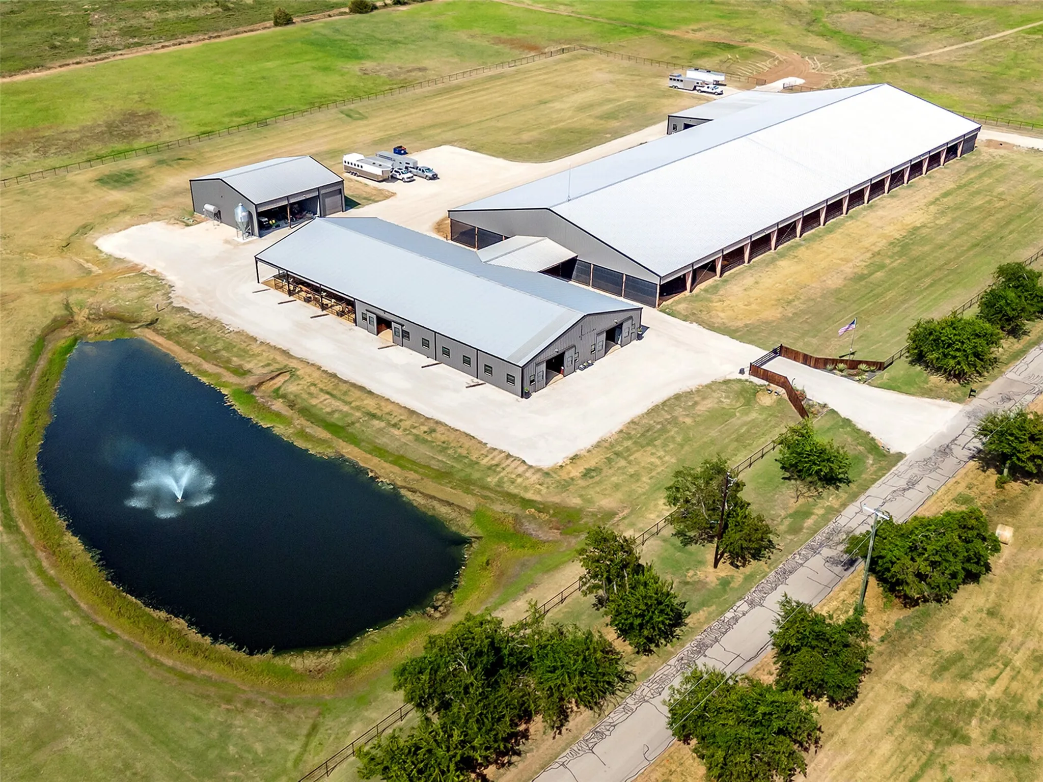 HORSE FACILITIES...Main Show Barn W/40 Stalls, Office, Breezeway Attaching Main Barn To Covered Arena, 2nd Show Barn W/12 Stalls & Attached To Side Of Arena + Equipment/Storage Bldg.